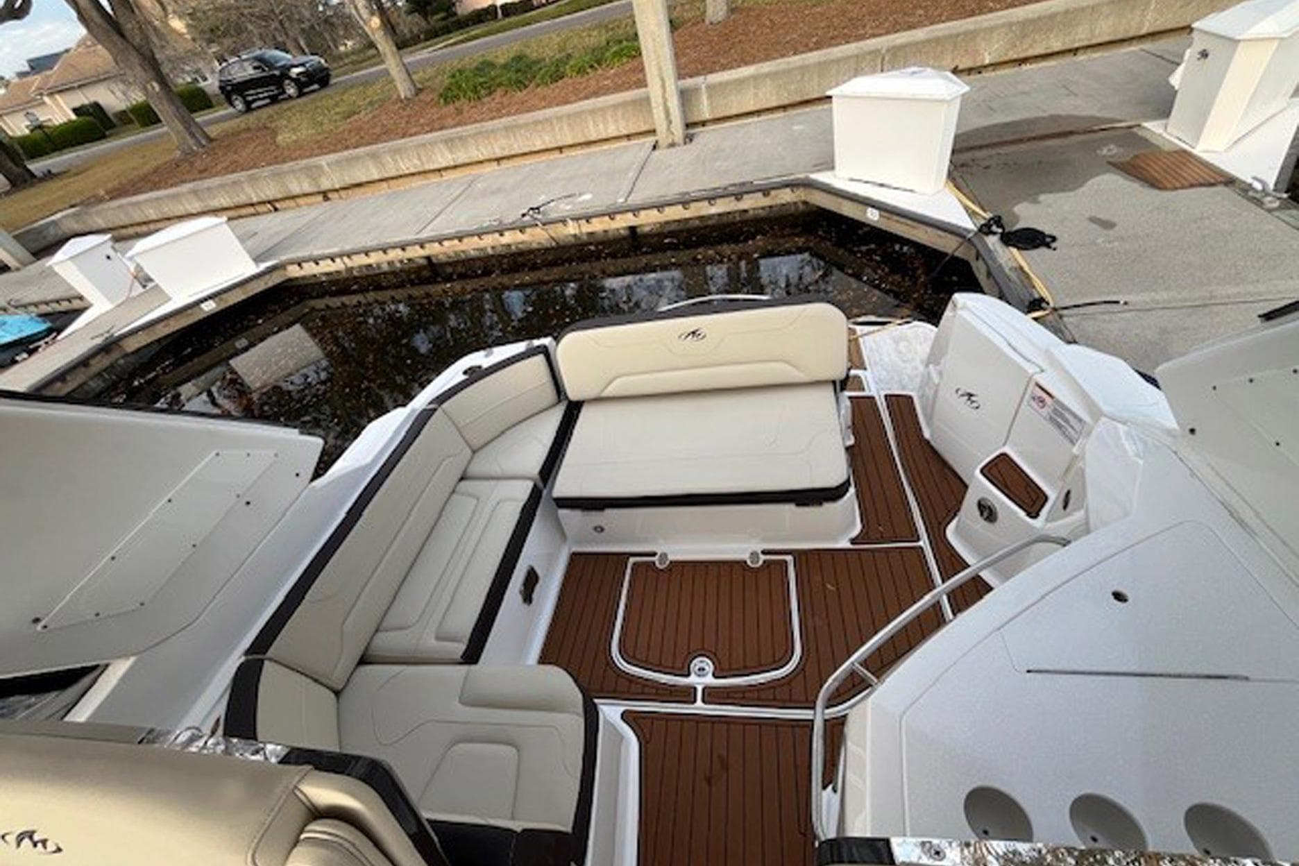 2018 Monterey 335 Sport Yacht interior with sleek seating and wood flooring.