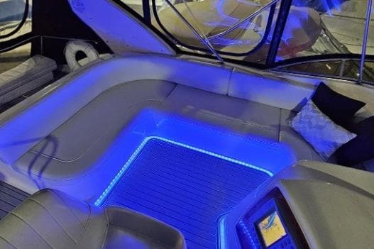 Luxurious interior of 2003 Meridian 381 Sedan yacht with blue LED lighting.