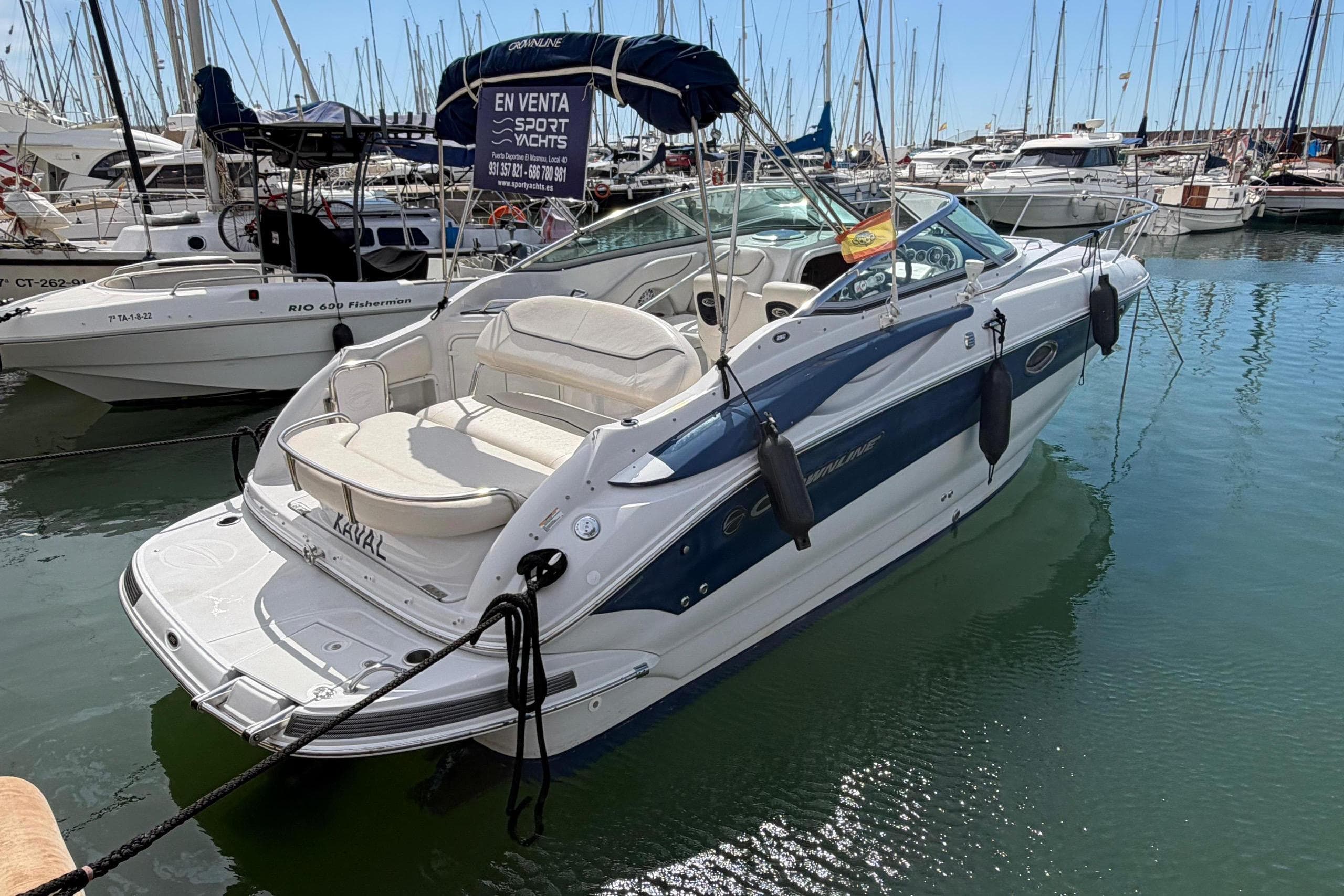 2007 Crownline 250 CR boat docked in a marina, surrounded by other vessels.