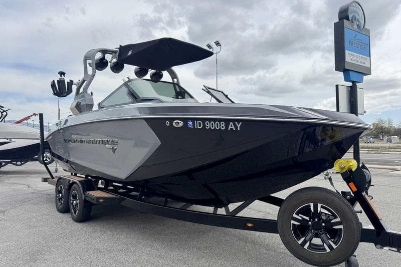 2019 Nautique Super Air Nautique G23 boat on trailer, parked outdoors.