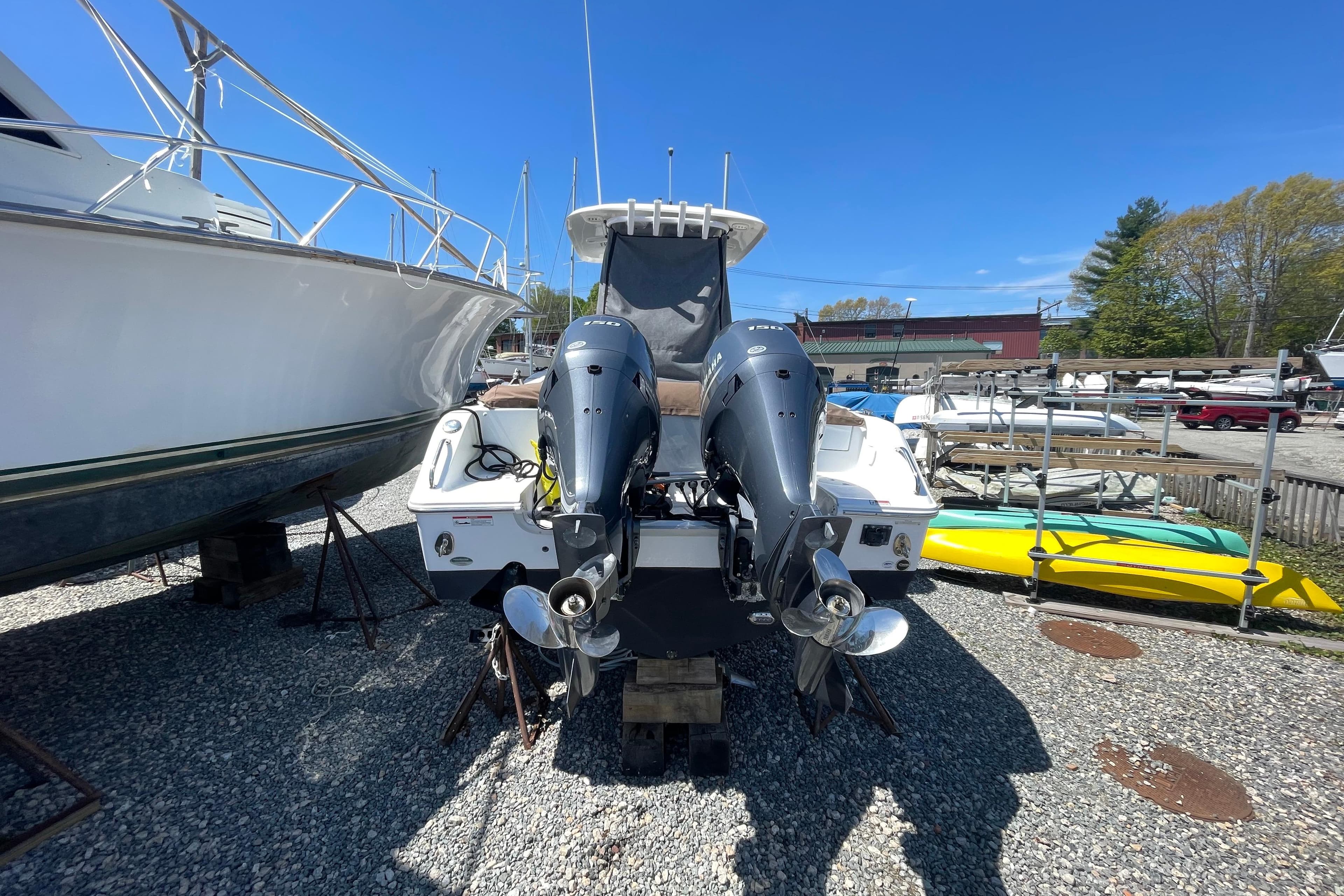 2022 Sea Hunt Ultra 265 SE boat with dual outboard motors in a marina setting.