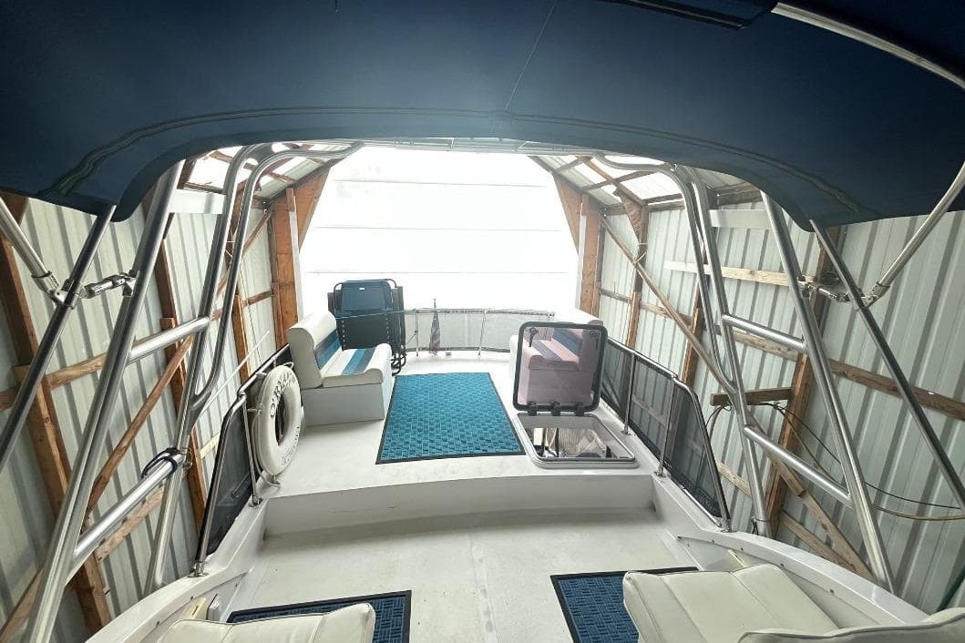 1976 Uniflite 32 Sport Sedan interior with blue canopy and seating area.