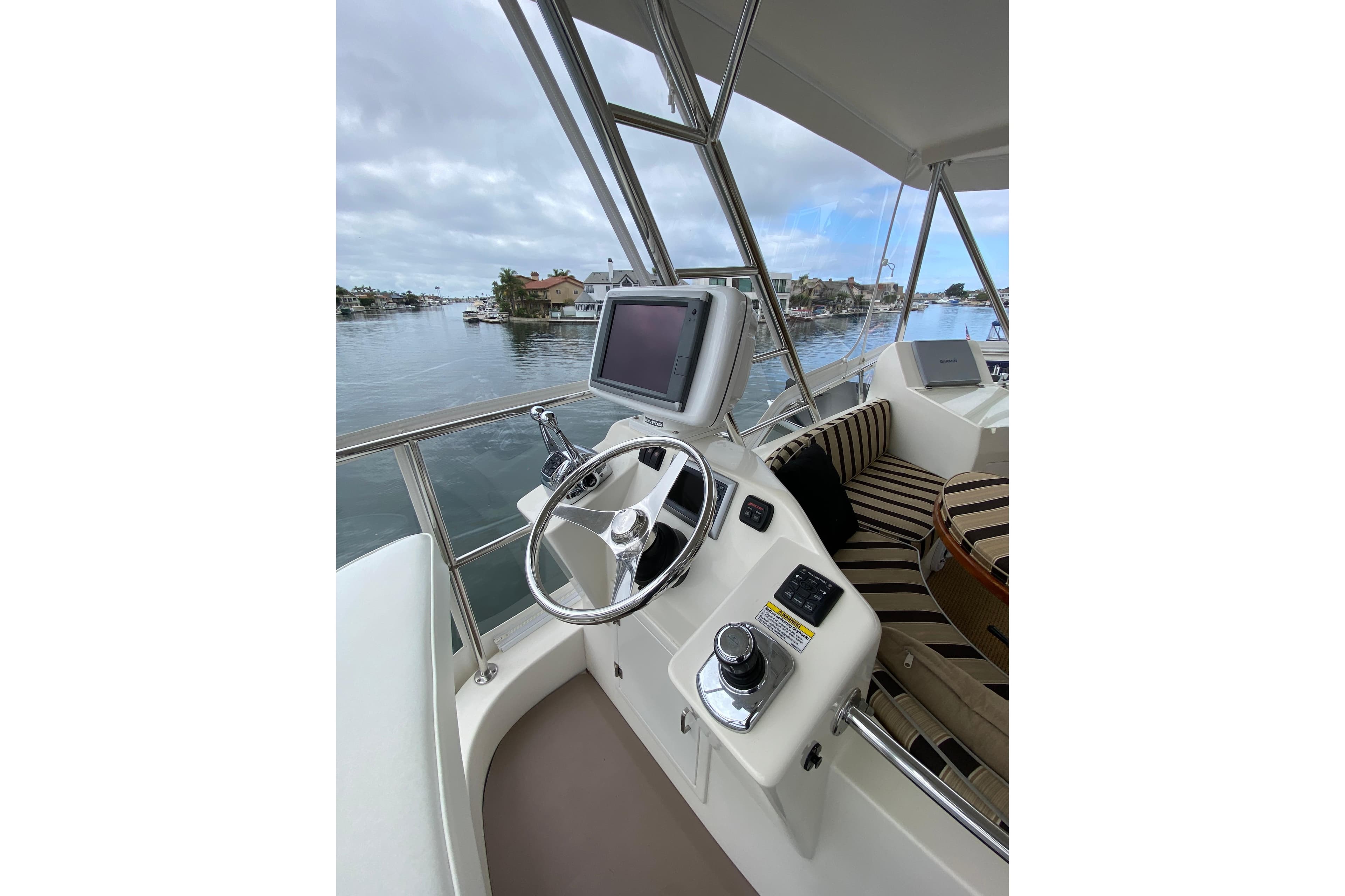 Helm of 2012 Mikelson 43 Sportfisher with steering wheel and navigation screen.
