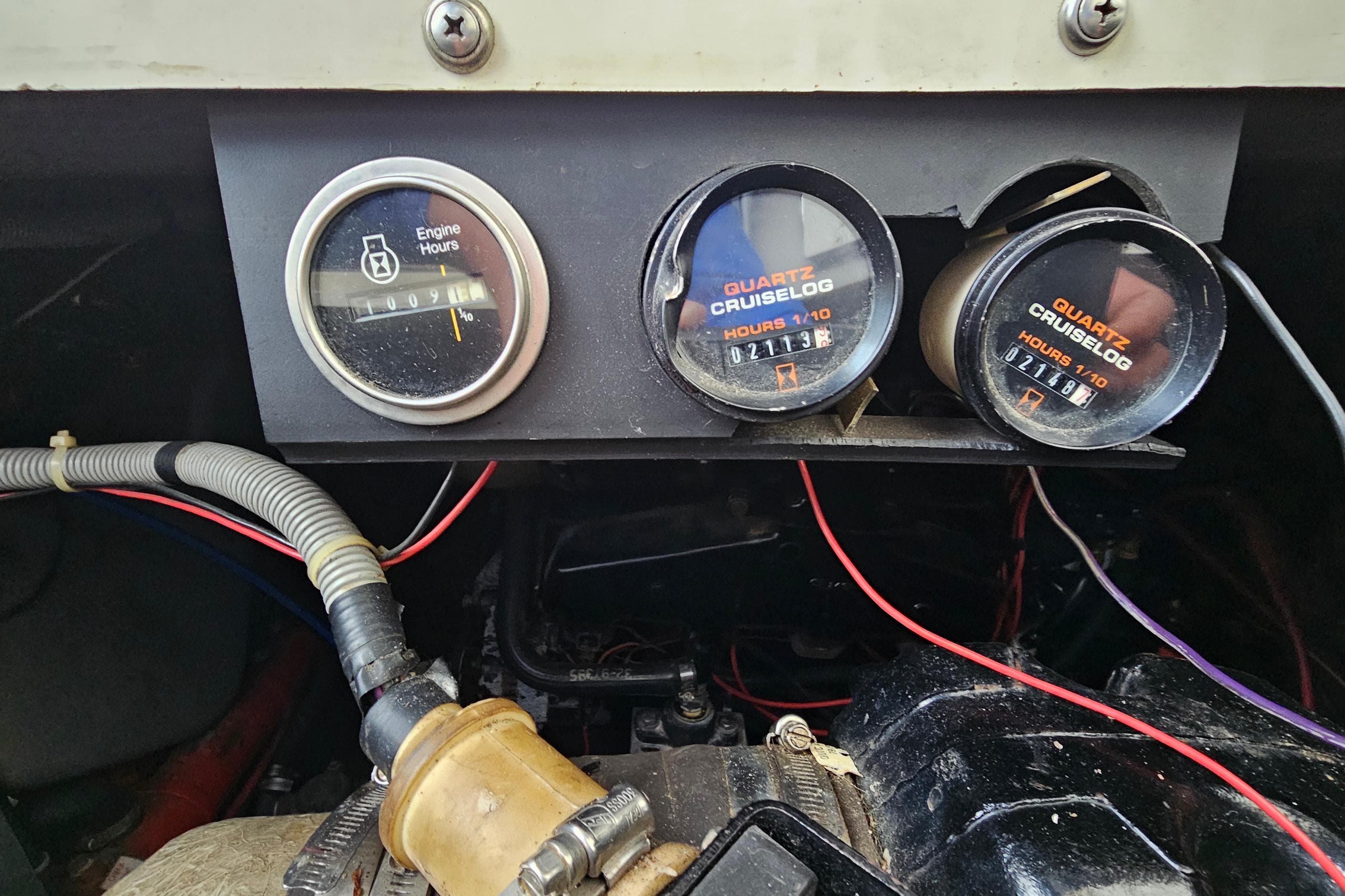 Dashboard of a 1988 Regal Commodore 360 with engine hour meters and wiring.