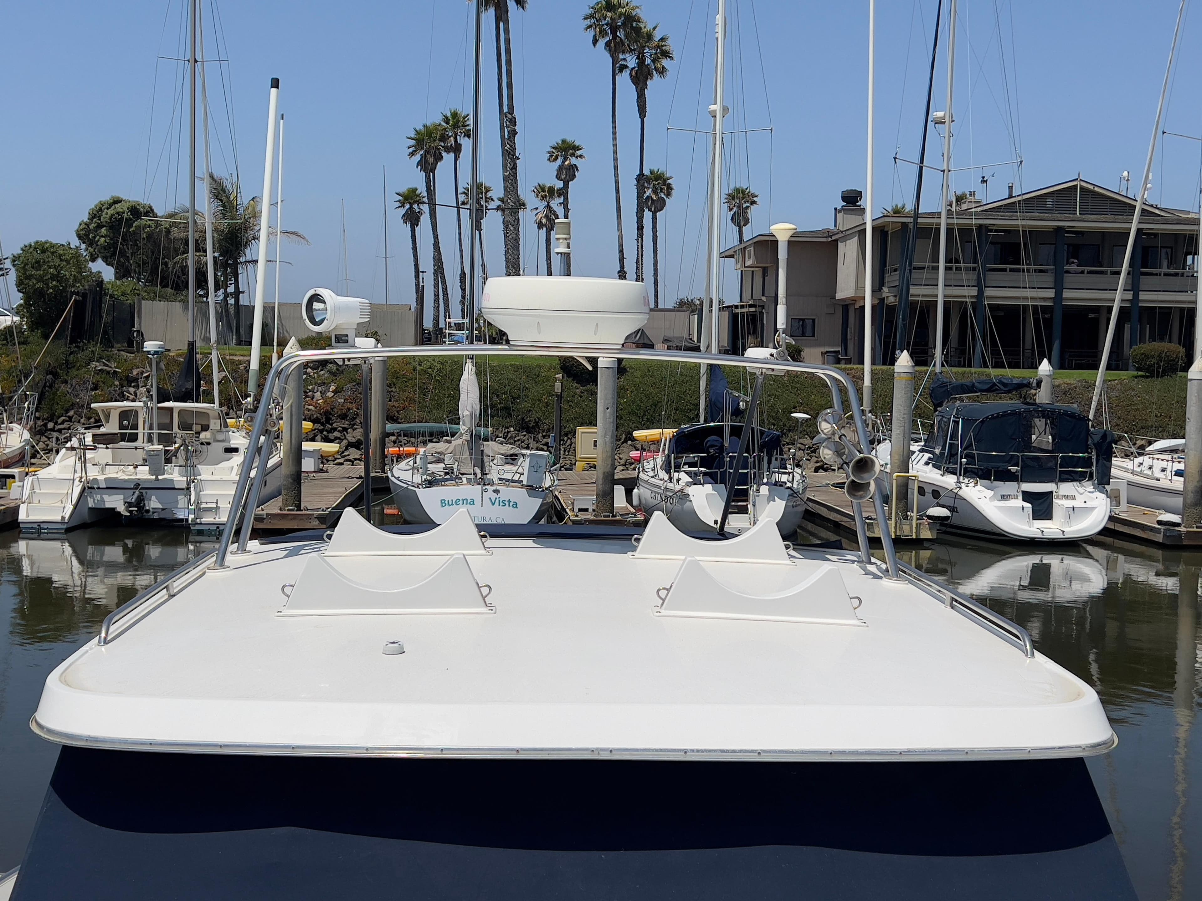Norstar 301 boat docked at marina, surrounded by sailboats and palm trees, 2001 model.