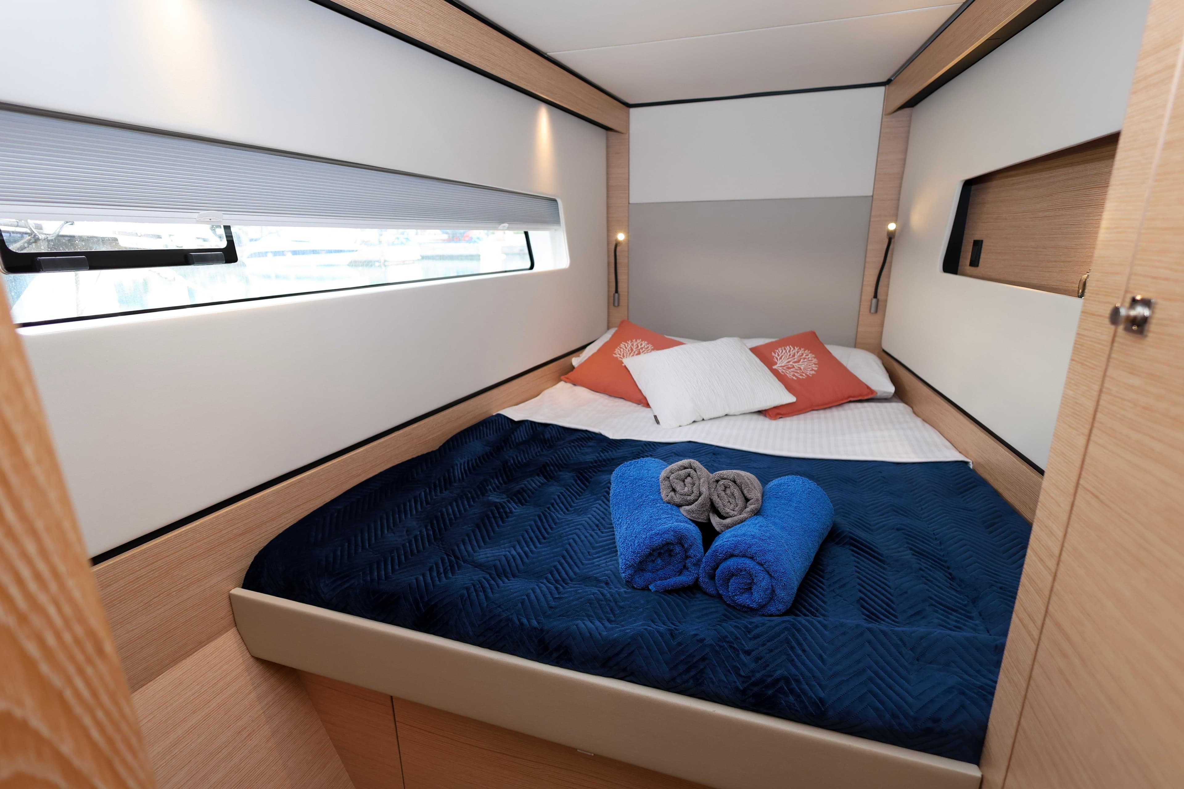 Luxurious cabin interior of 2023 Nautitech 44 Open yacht with cozy bedding and towels.