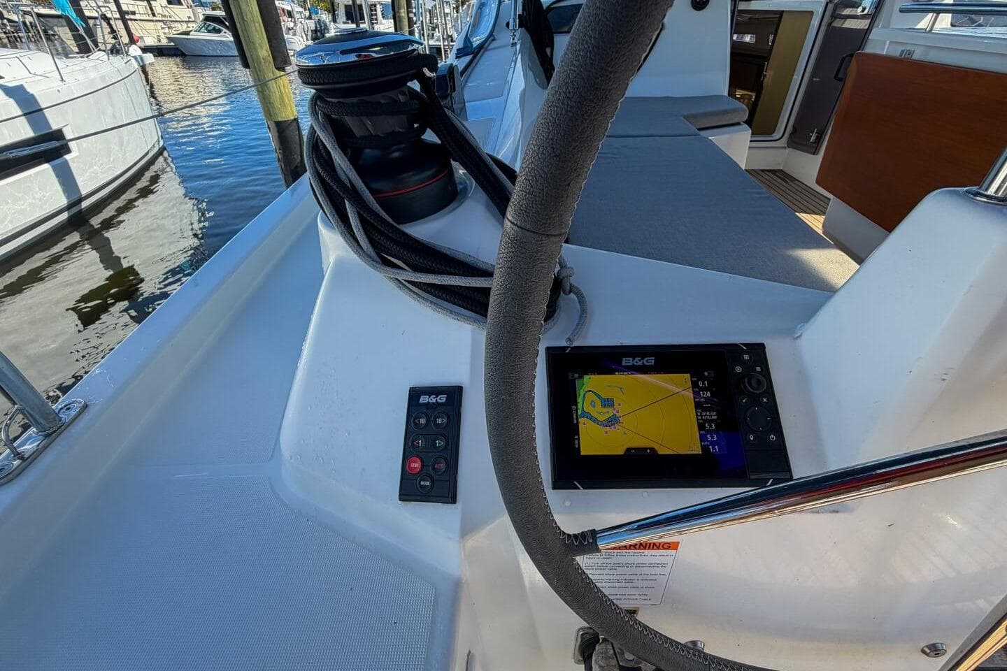 Cockpit of 2022 Beneteau Oceanis 40.1 with navigation display and steering wheel.