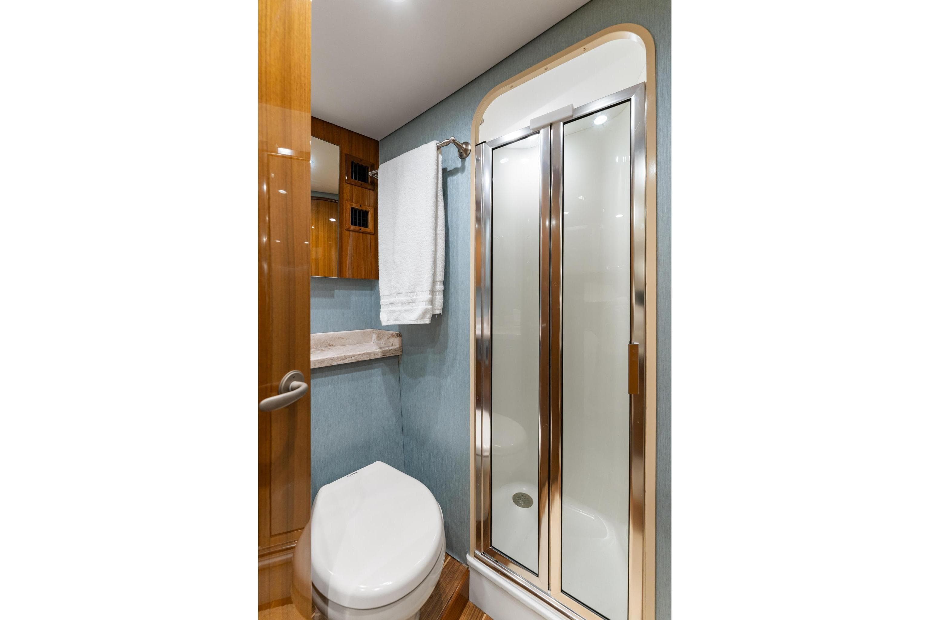 Bathroom interior of 2018 Viking 44 Express yacht with shower and toilet.