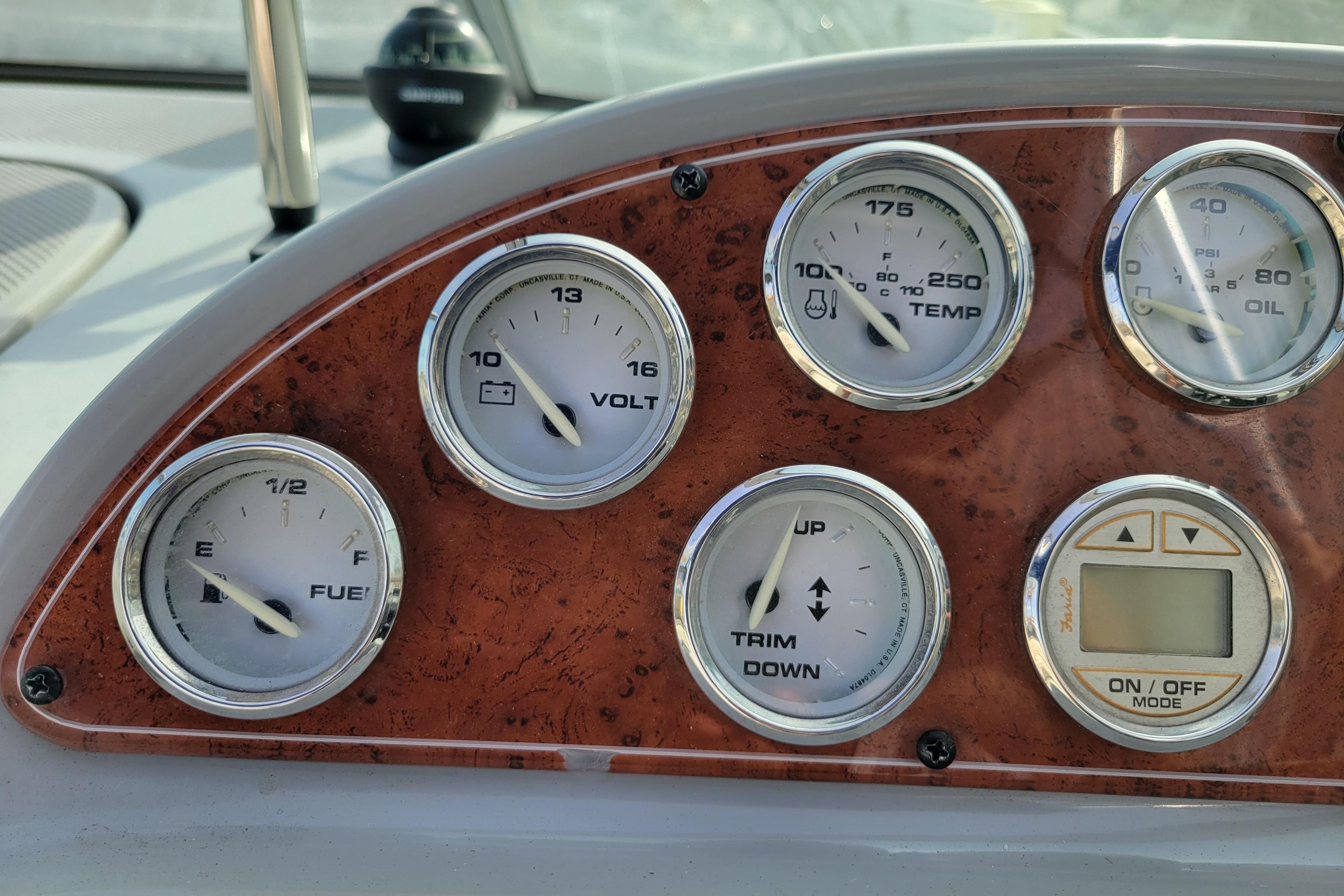 Dashboard gauges of a 2007 Bayliner 245 Cruiser boat, showing fuel, voltage, temperature, and oil levels.