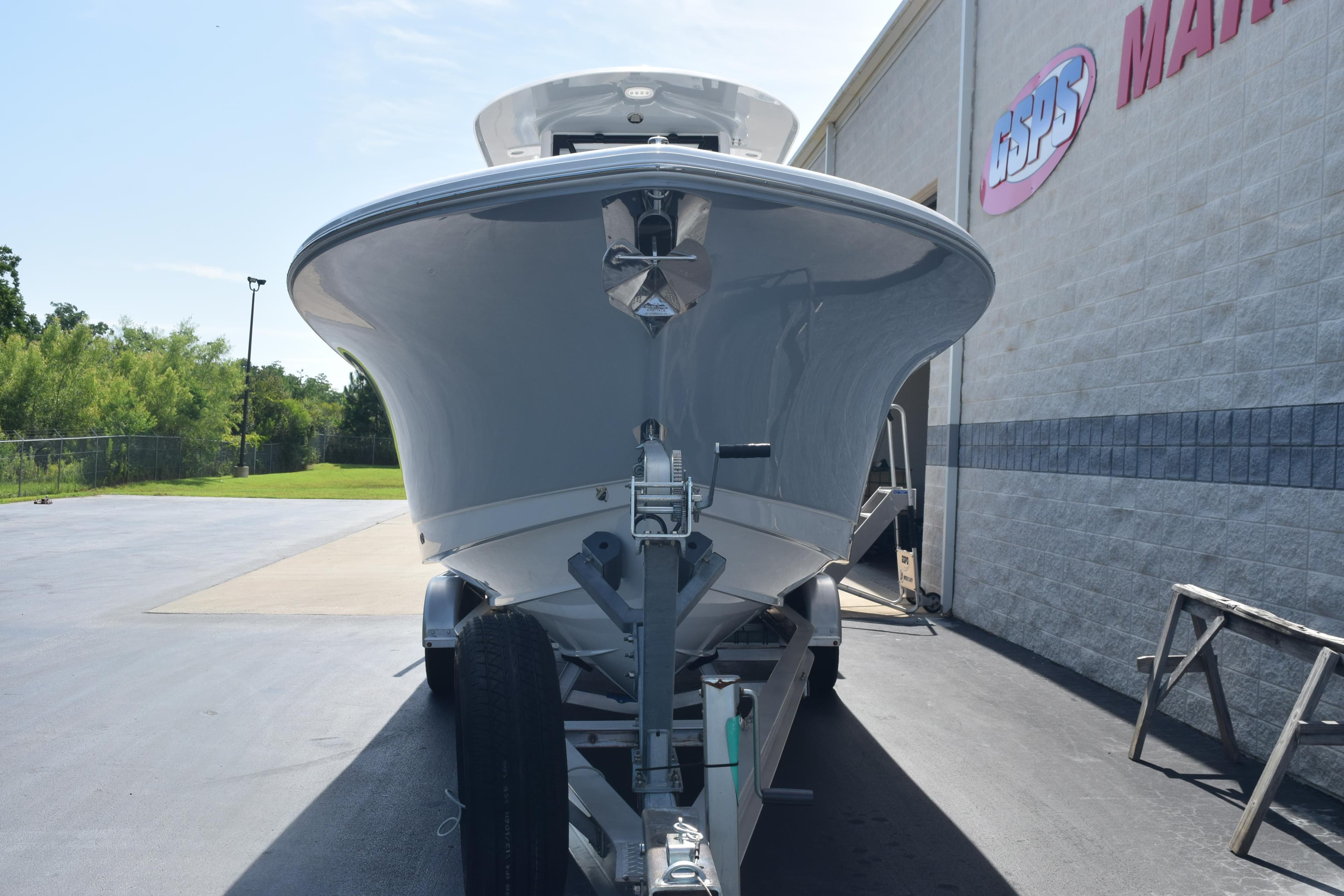 2026 Sea Hunt Gamefish 27 boat on trailer, parked outside a marine dealership.