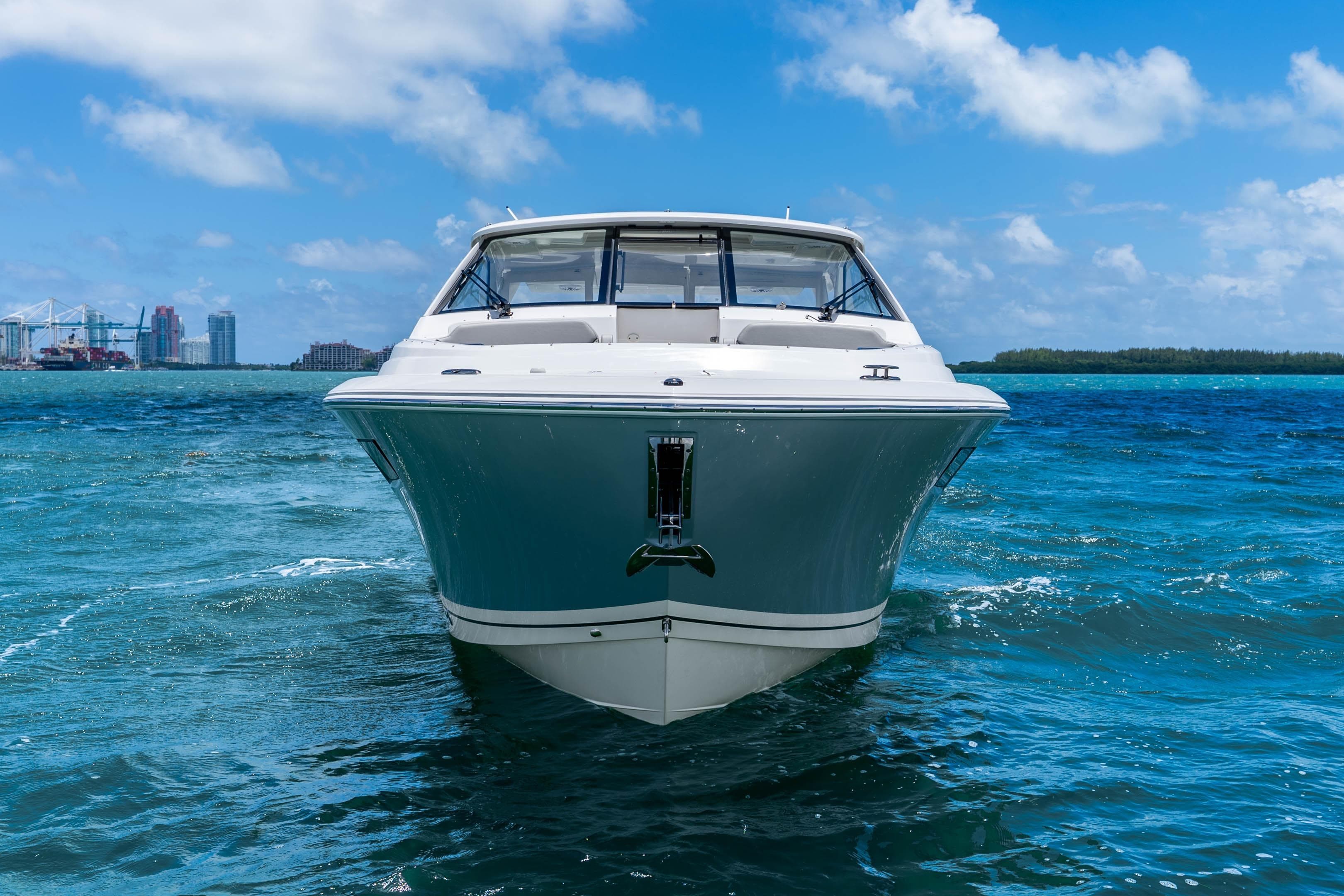 2026 Pursuit DC 365 Dual Console boat cruising on clear blue ocean waters.
