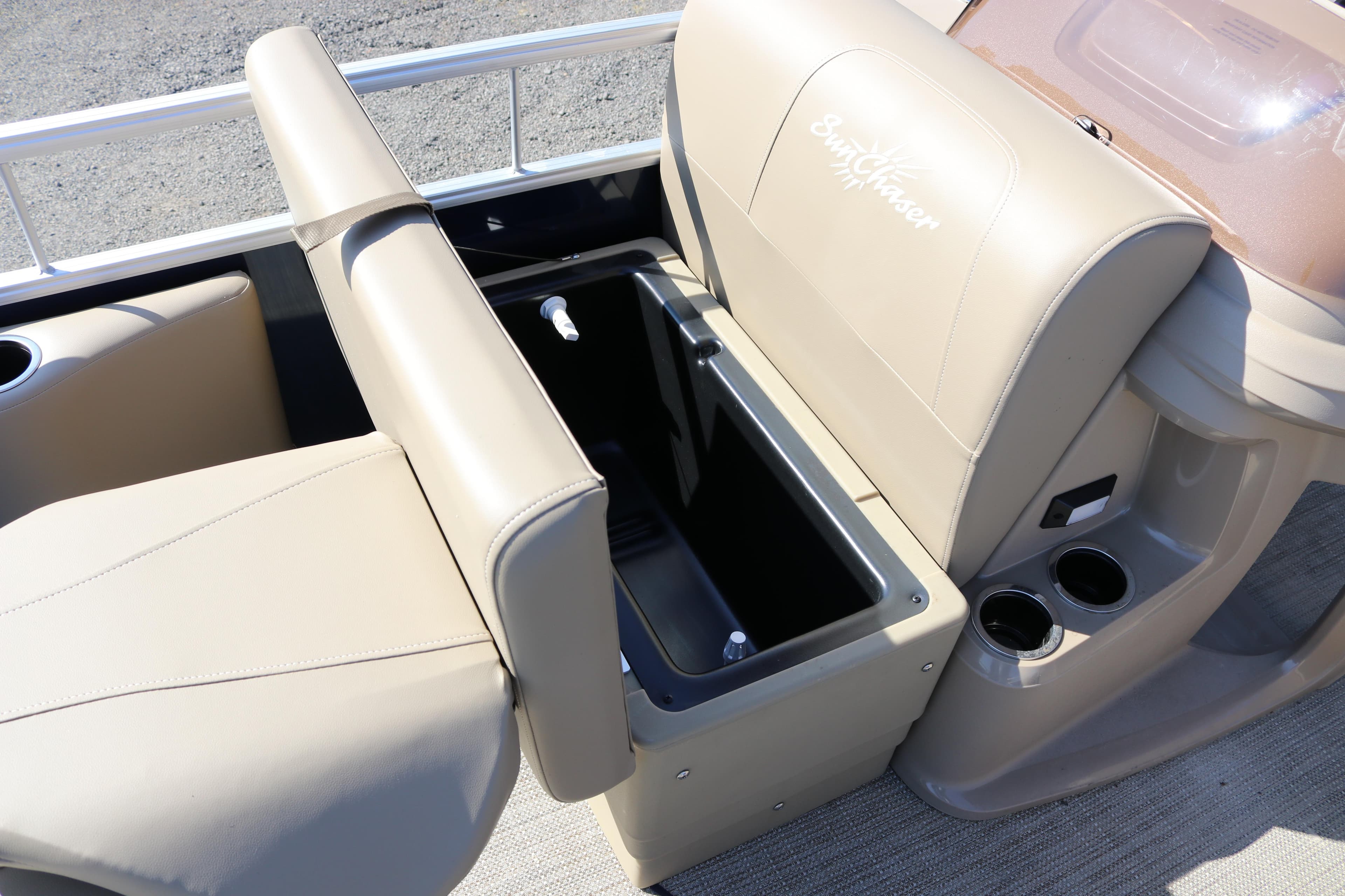 2025 Sun Chaser Vista Fish 18 boat interior with beige seating and storage compartment.