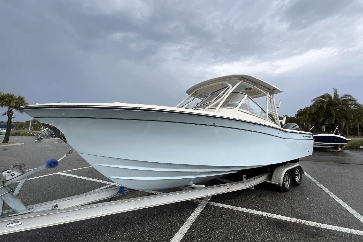 2023 Grady-White Freedom 275 boat on trailer in parking lot.