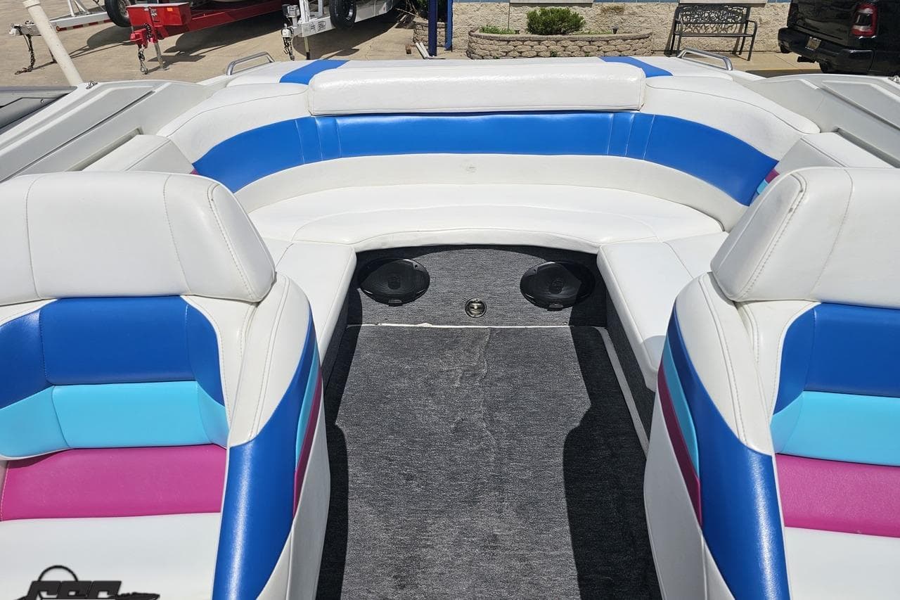 1997 Formula 252 SS boat interior with colorful seating and carpeted floor.