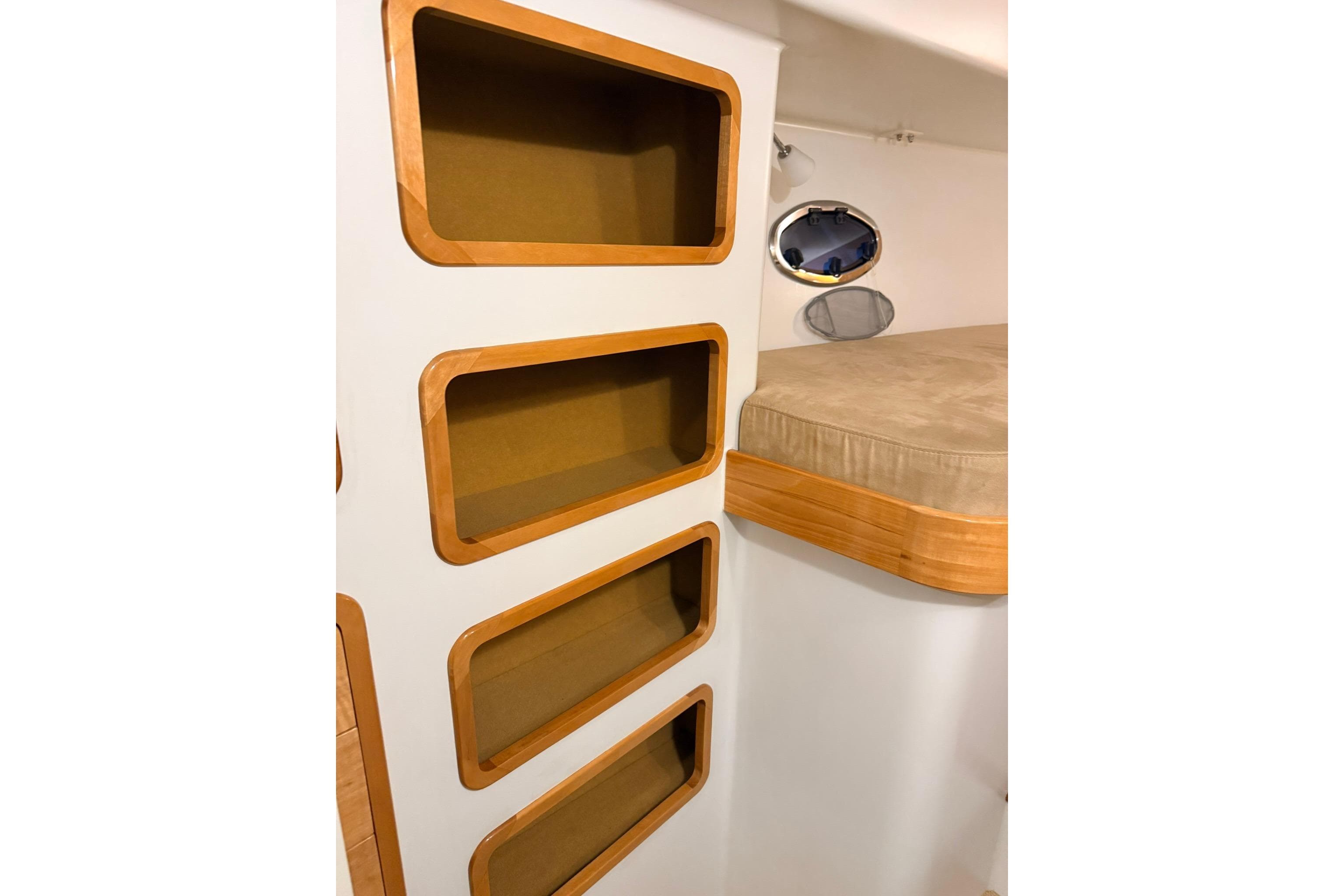 Interior of 2002 Norris Custom Motor Catamaran 41.4 with built-in shelves and bed.
