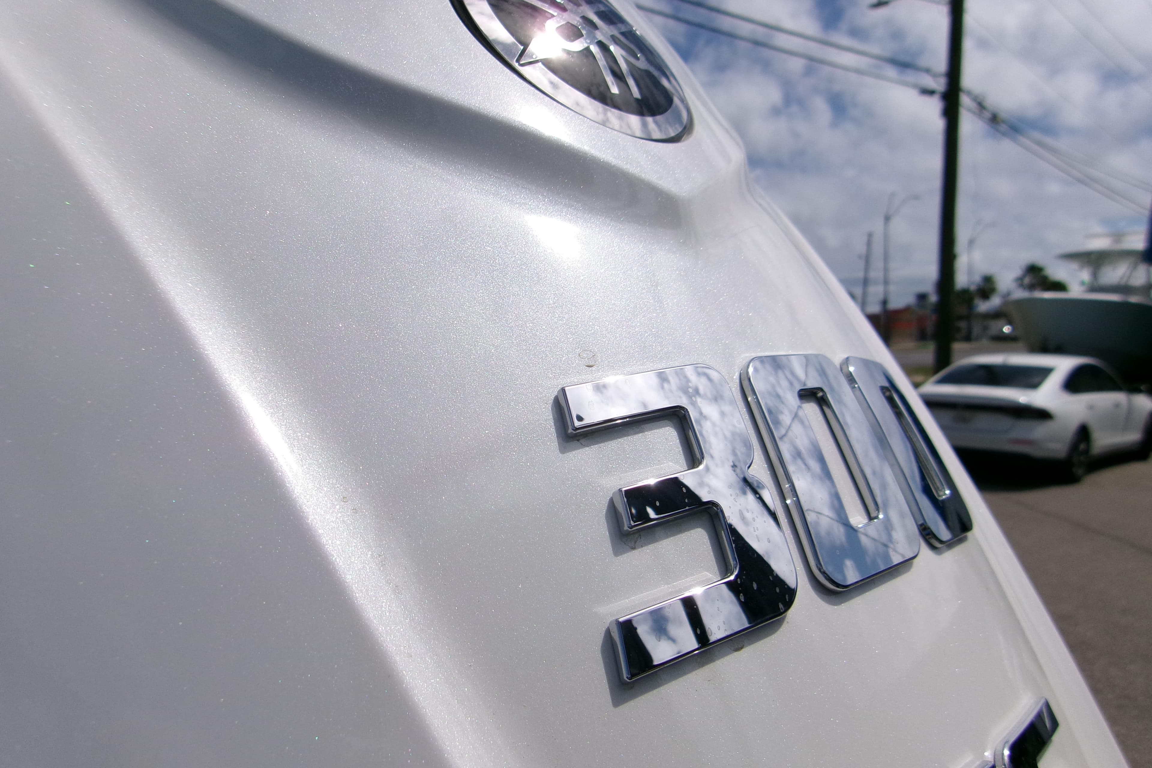 Close-up of a 2026 Sportsman Open 232 Center Console boat engine with "300" emblem.