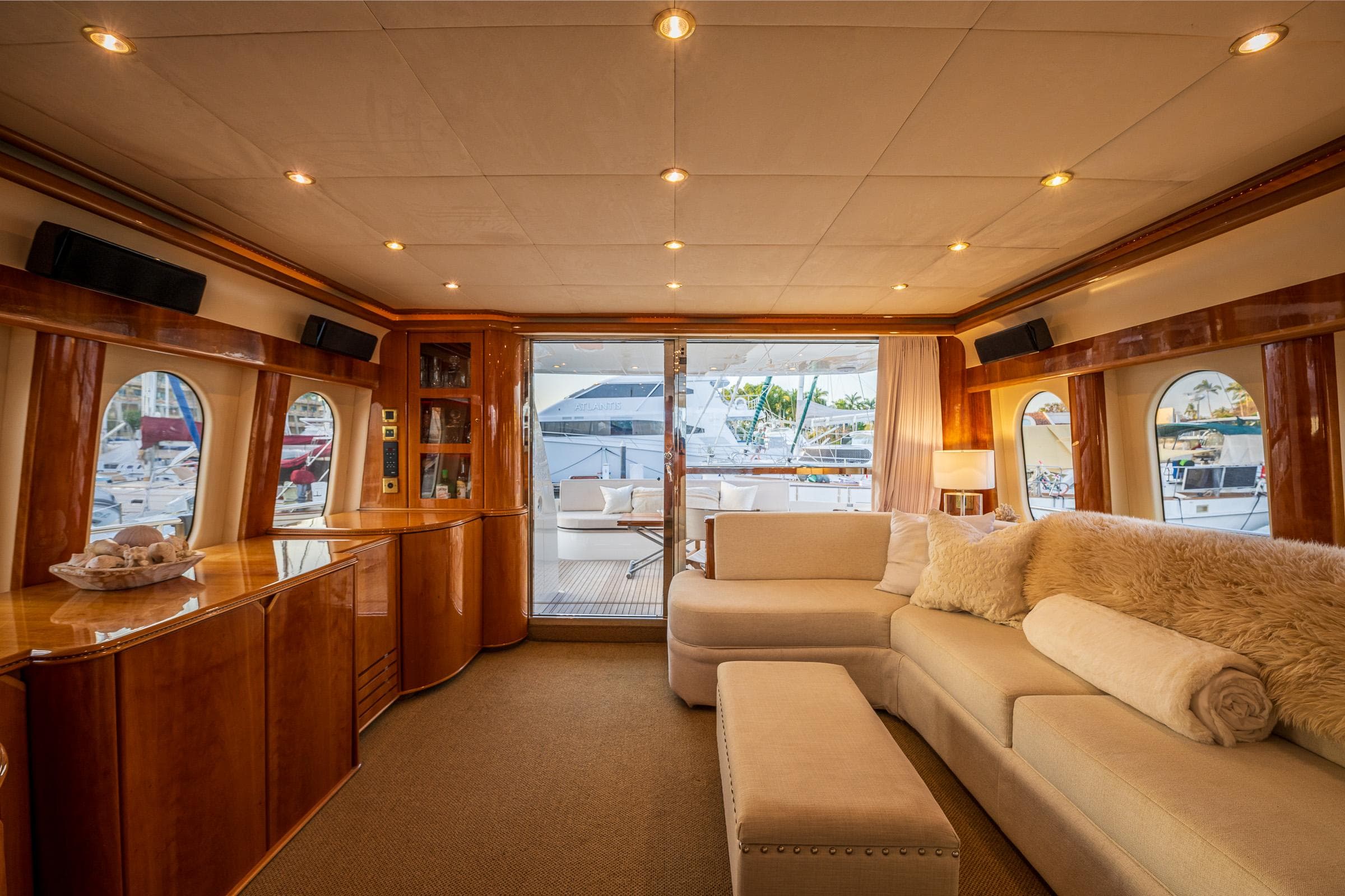 Luxurious interior of 2002 Viking Princess 72 SportCruiser yacht with plush seating and elegant wood finishes.