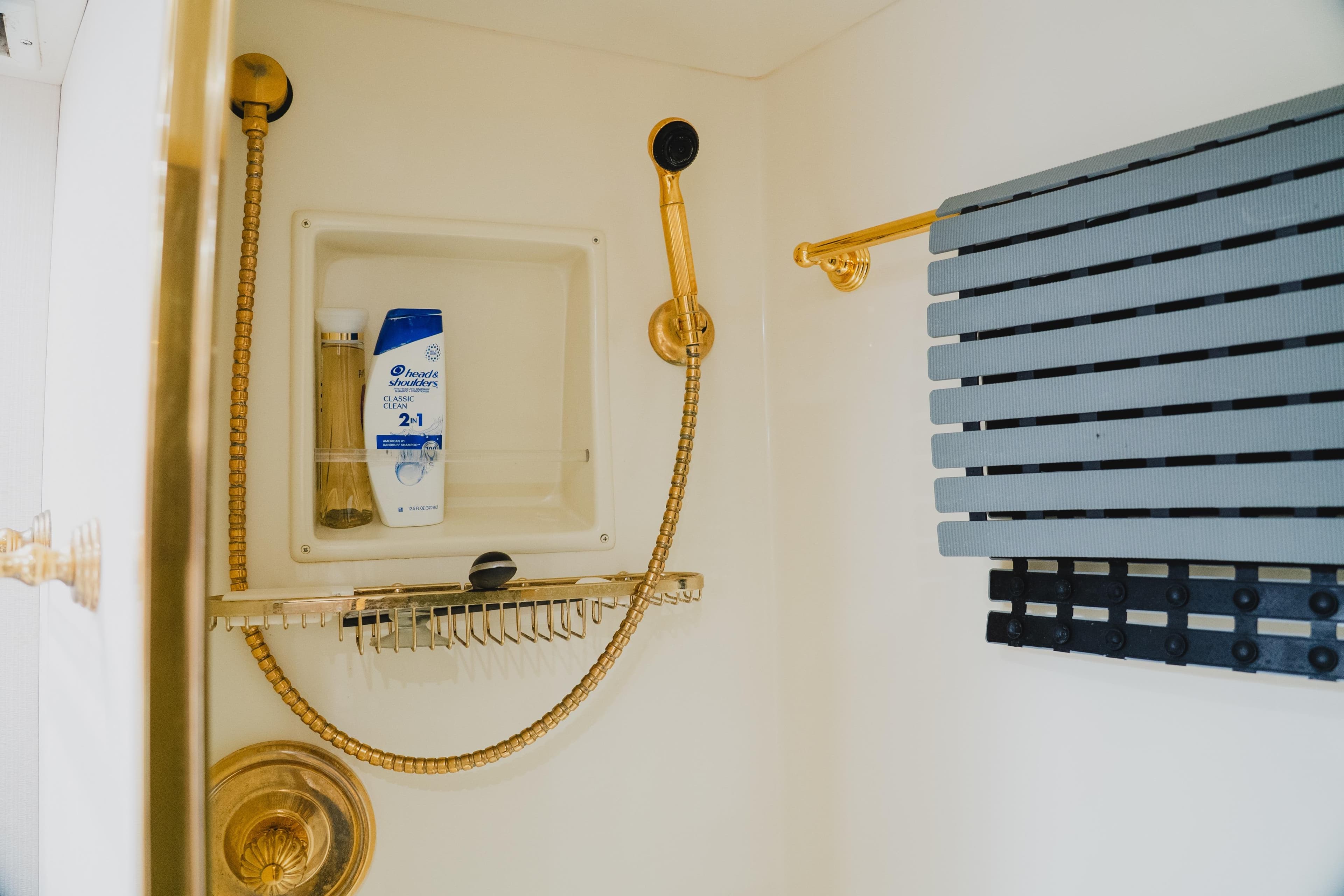 Shower area in 1999 Viking 58 Convertible yacht with gold fixtures and toiletries.