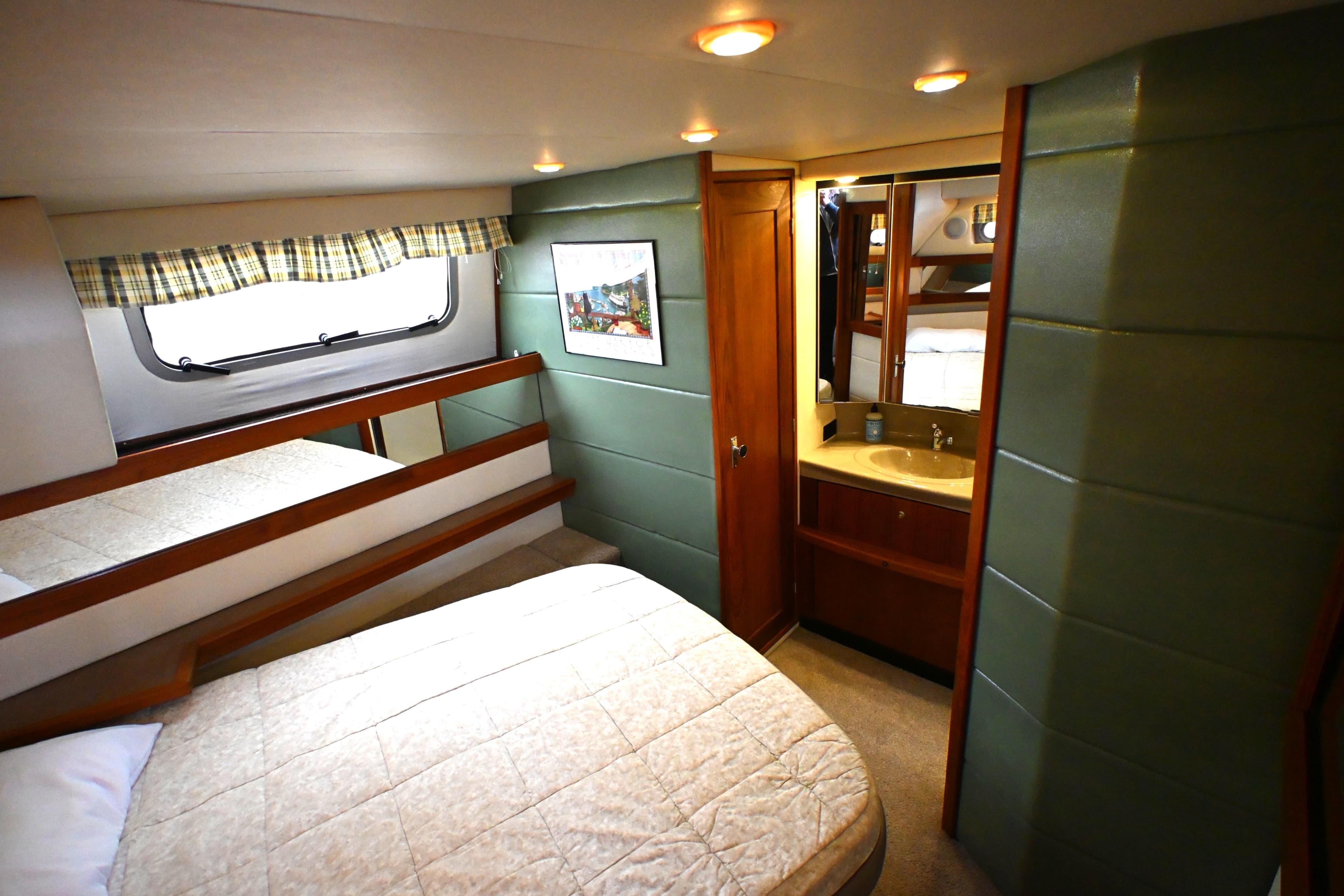 1996 Bayliner 4087 Aft Cabin Motoryacht interior with cozy bedroom and ensuite bathroom.