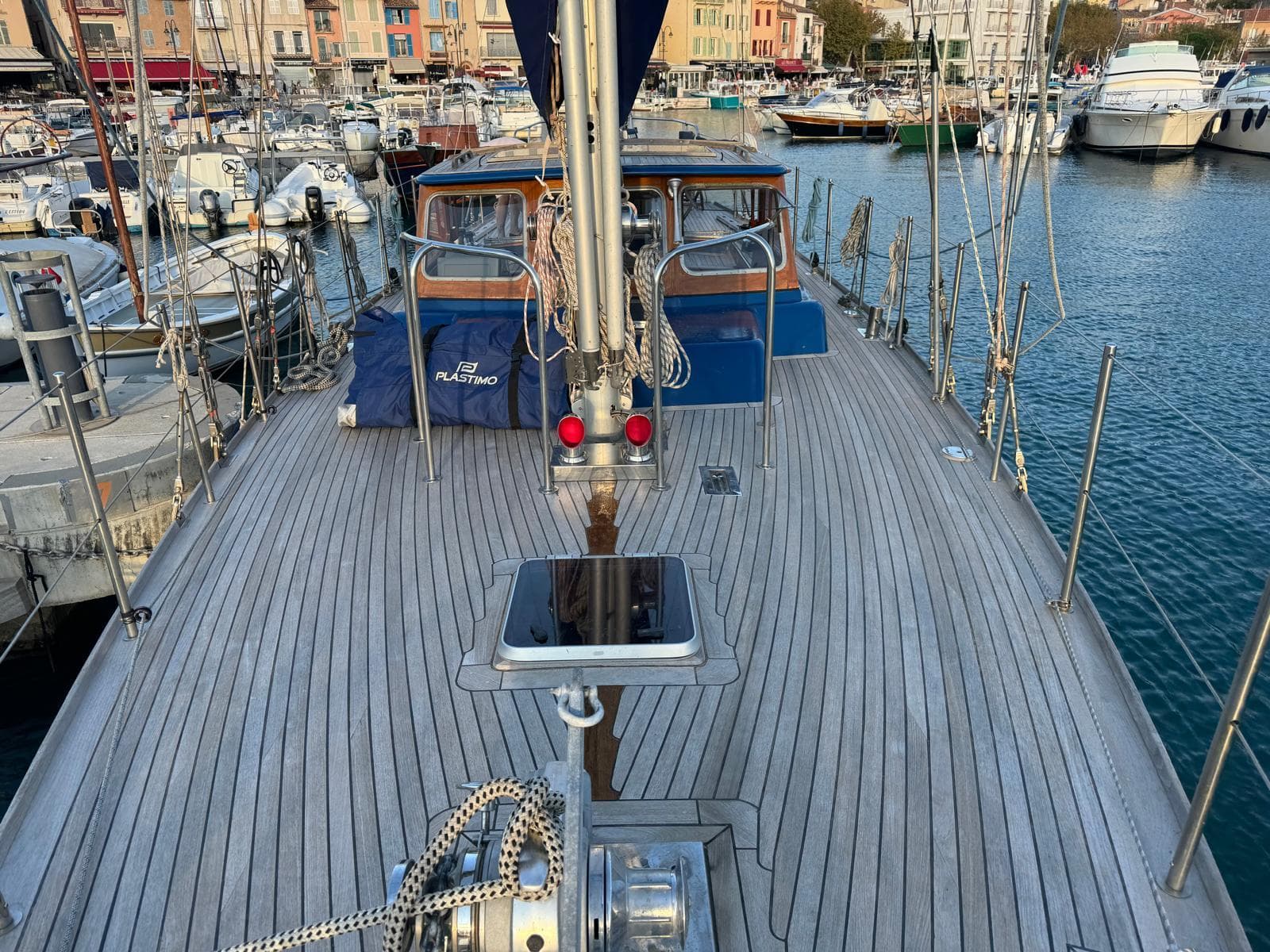 1974 Jongert 53 sailboat deck view in marina, showcasing wooden finish and nautical equipment.
