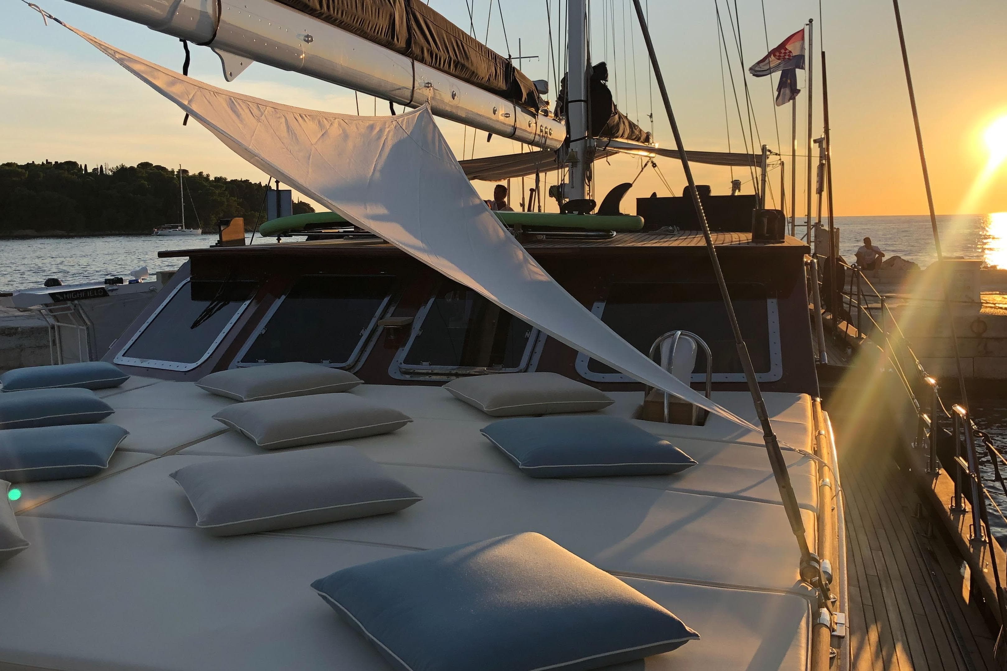 Luxurious 2007 Neta Marine yacht at sunset, featuring cushioned deck and elegant design.