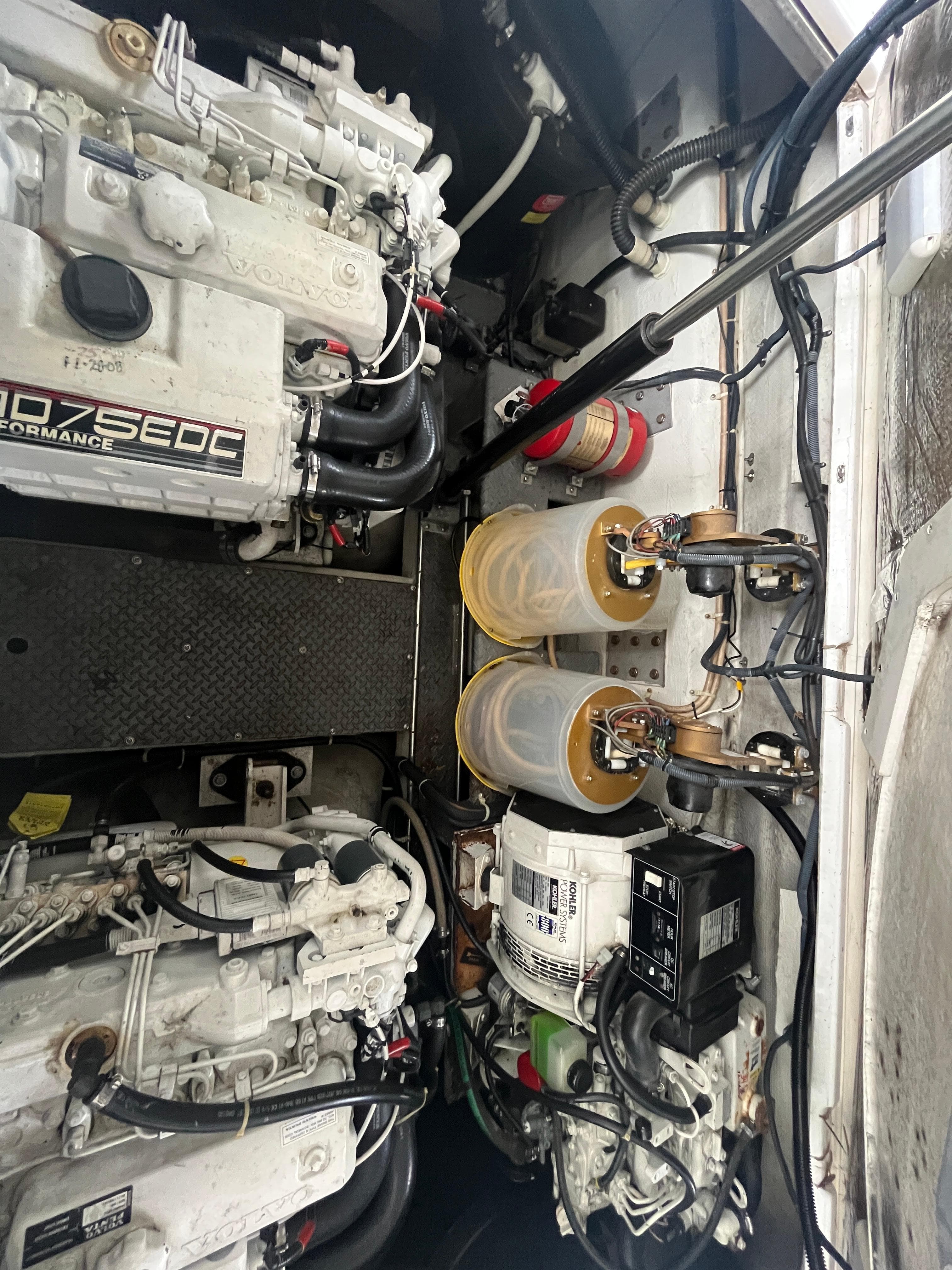 Engine compartment of a 2004 Regal Commodore 4260 boat, showcasing mechanical components and systems.