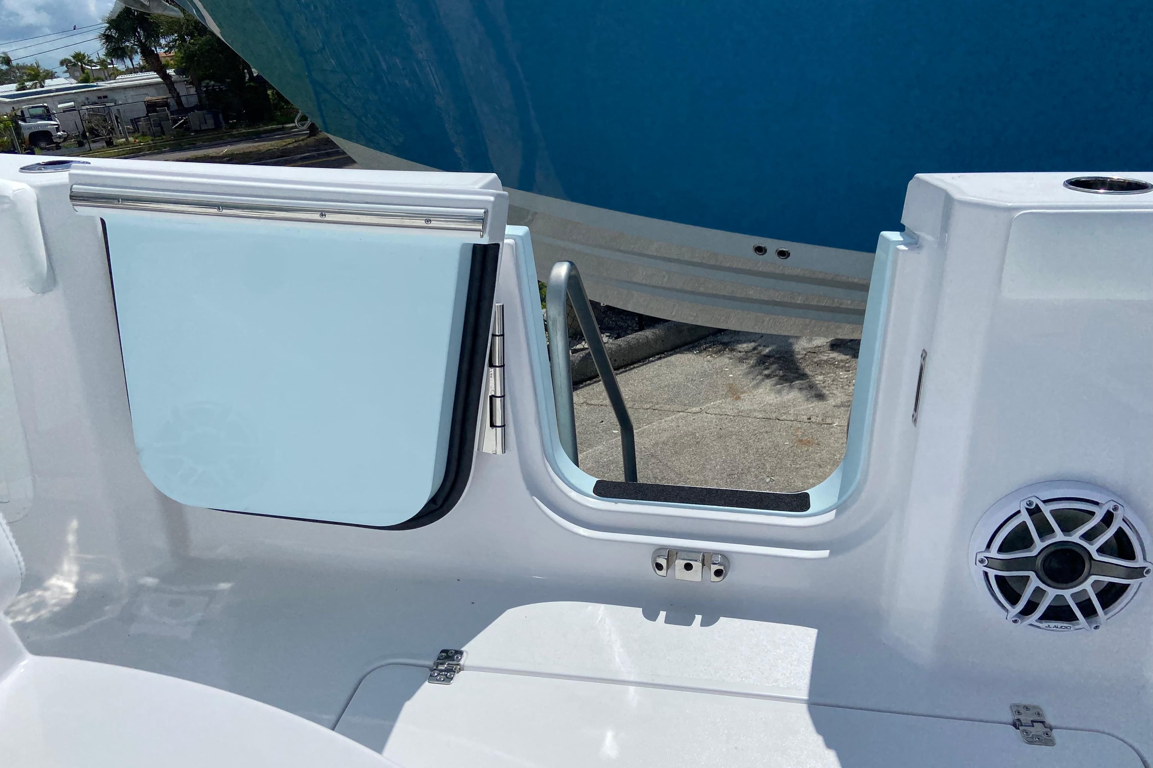 2026 Sportsman Heritage 321 Center Console boat with open side door and speaker detail.