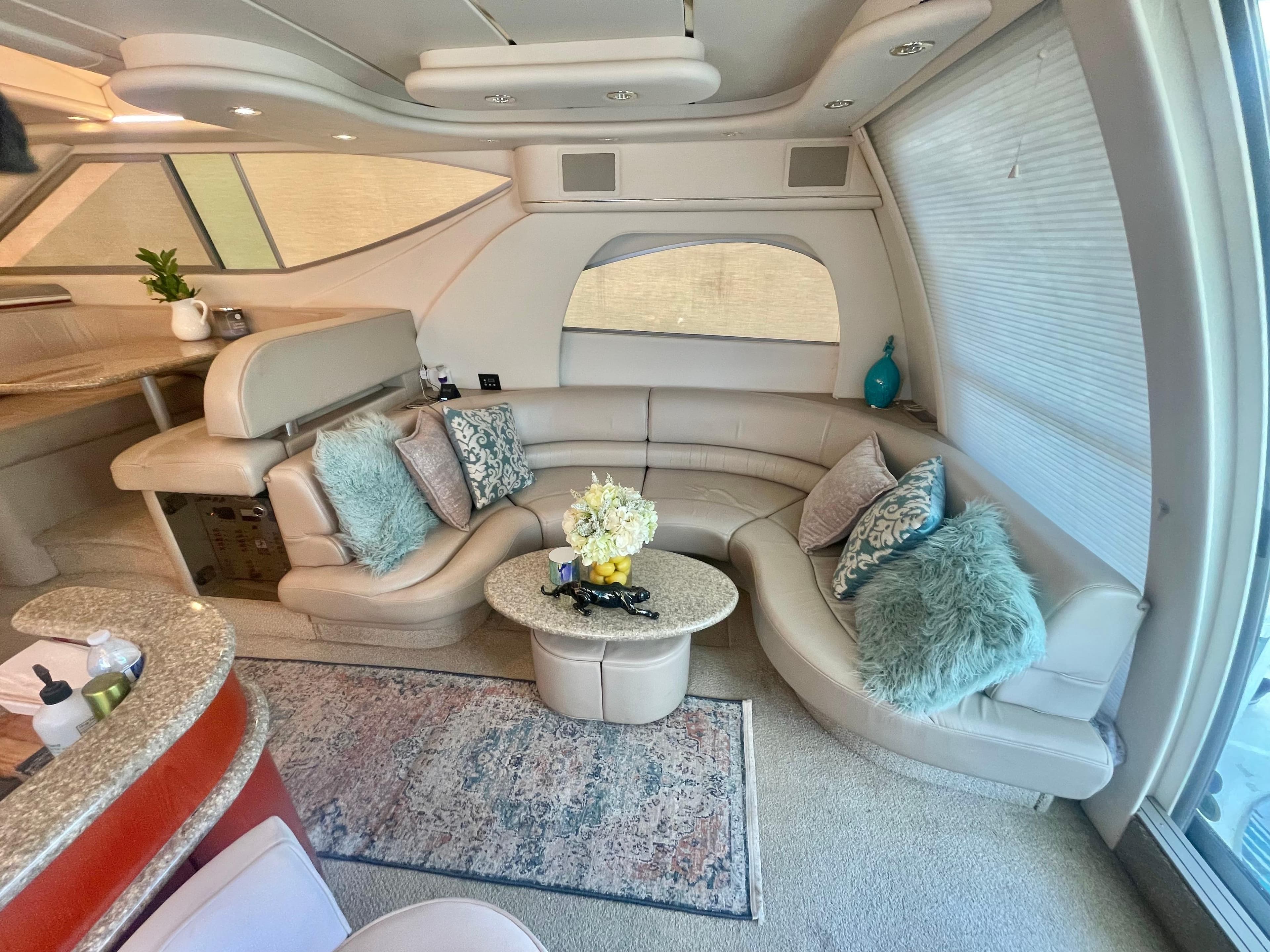 Luxurious interior of 1998 Maxum 4100 SCA yacht with plush seating and elegant decor.
