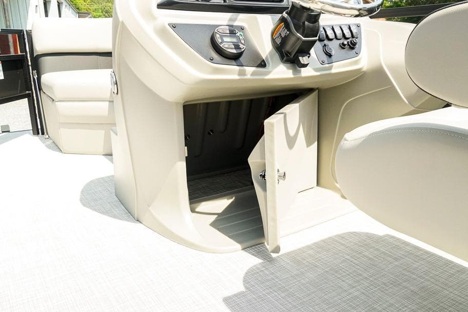 Interior view of 2026 Dockside 22DF boat console with open storage compartment.