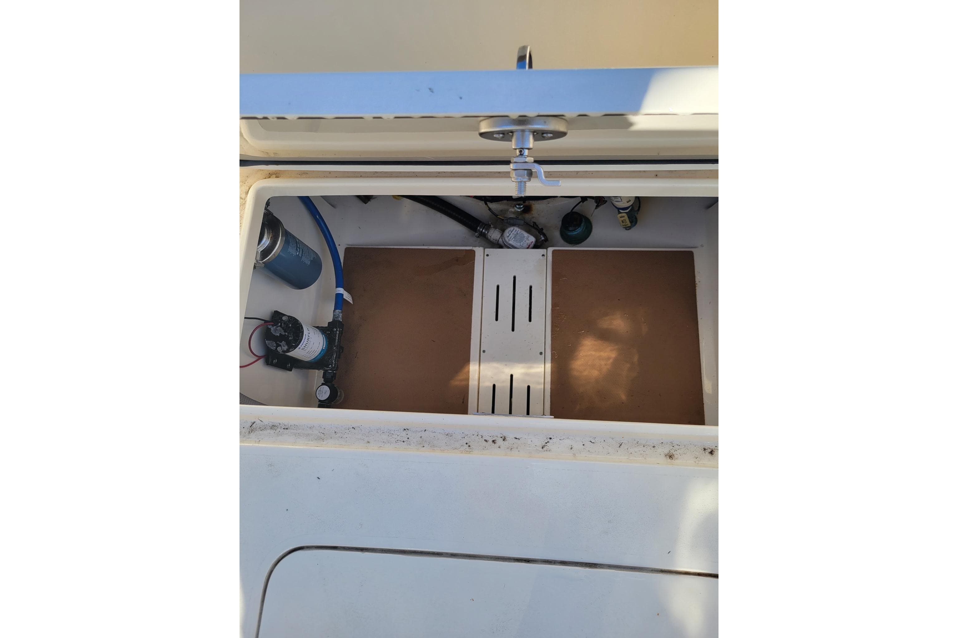 2020 Scout 255 Dorado boat storage compartment with plumbing and equipment.