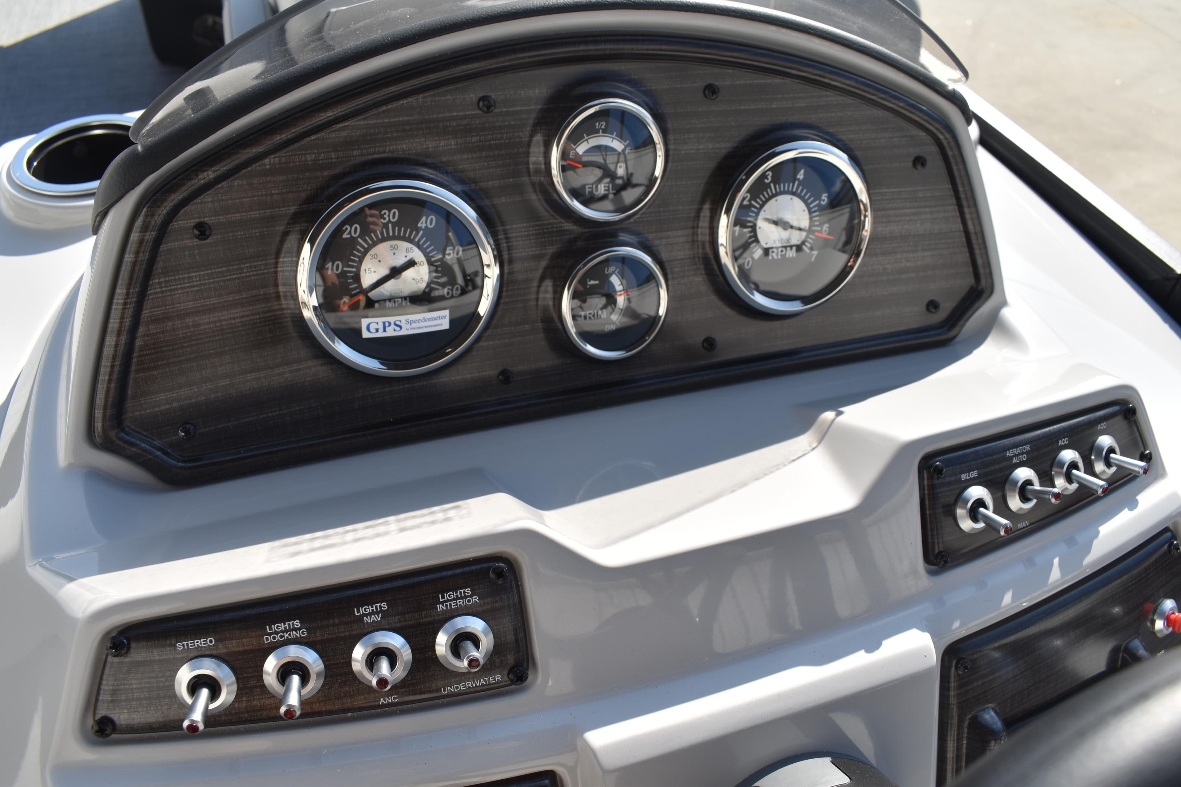 Dashboard of 2026 Lowe SF 232 Sport Fish boat with gauges and control switches.
