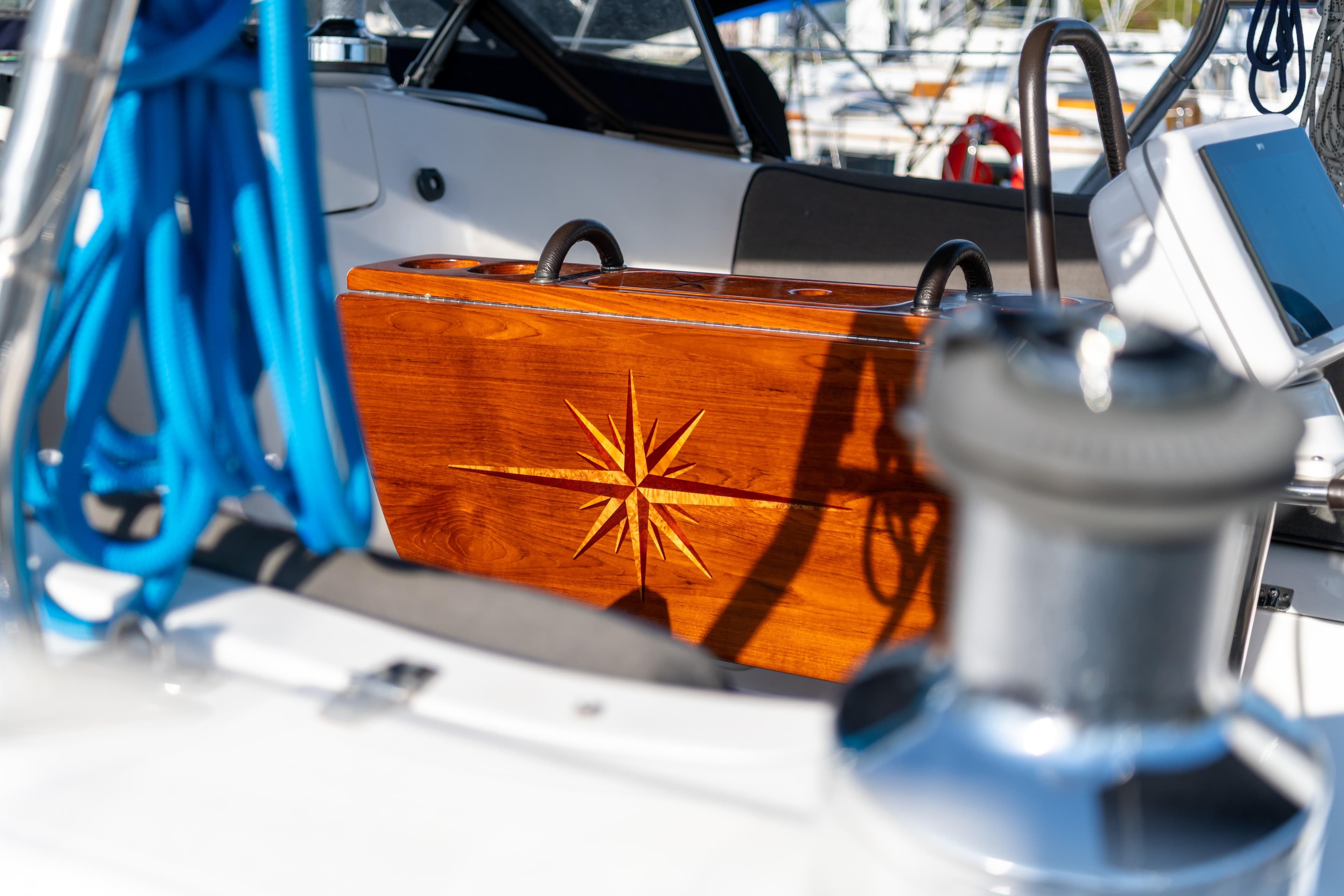 Interior of 2007 Hunter 49 sailboat with wooden compass rose detail.