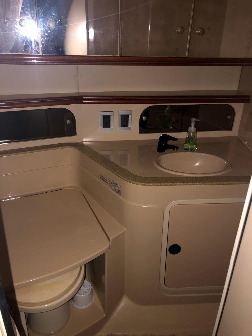 Bathroom of 2000 Cruisers Yachts 3575 Express with sink and storage.