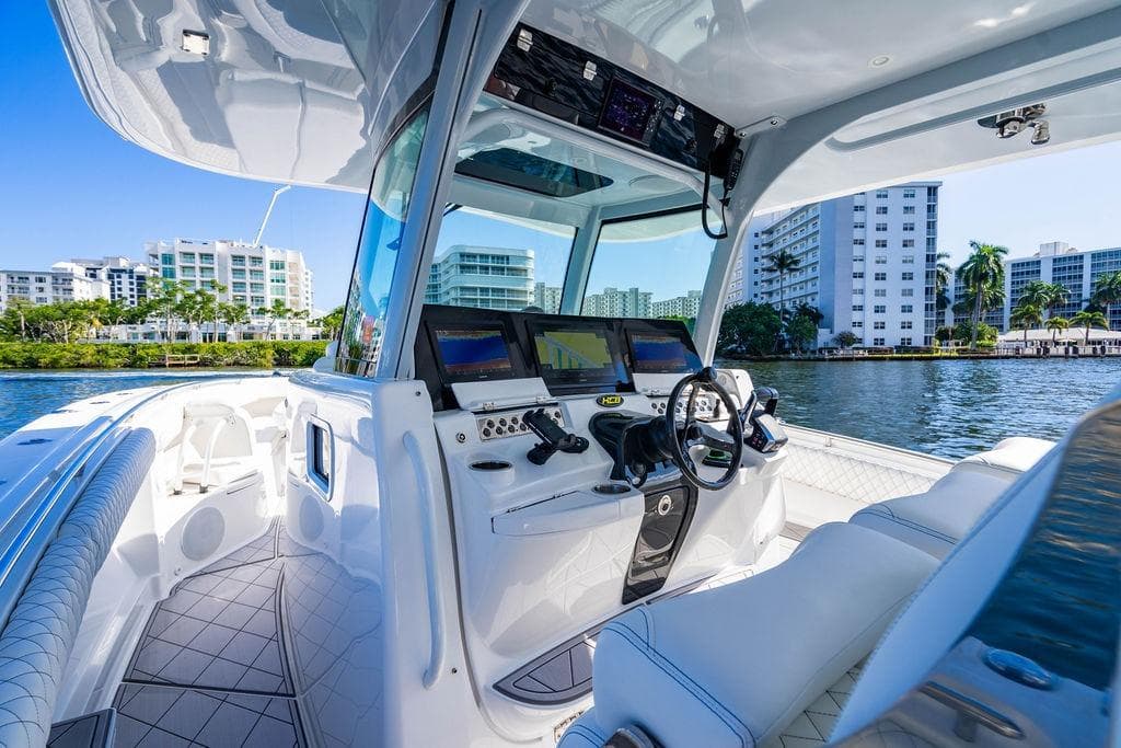 2024 HCB 42 Lujo boat interior with modern dashboard and waterfront view.