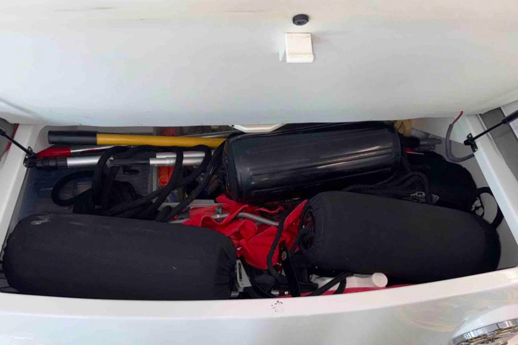 Storage compartment of a 2015 Formula 400 FX boat filled with boating equipment.