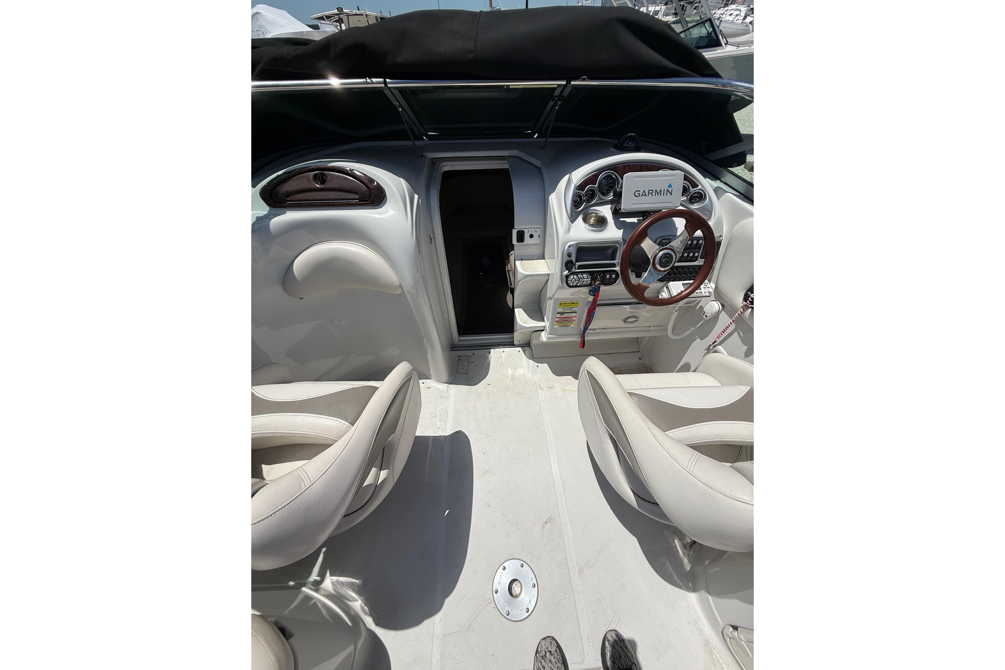 2011 Crownline 236 SC boat interior with steering wheel and Garmin navigation system.