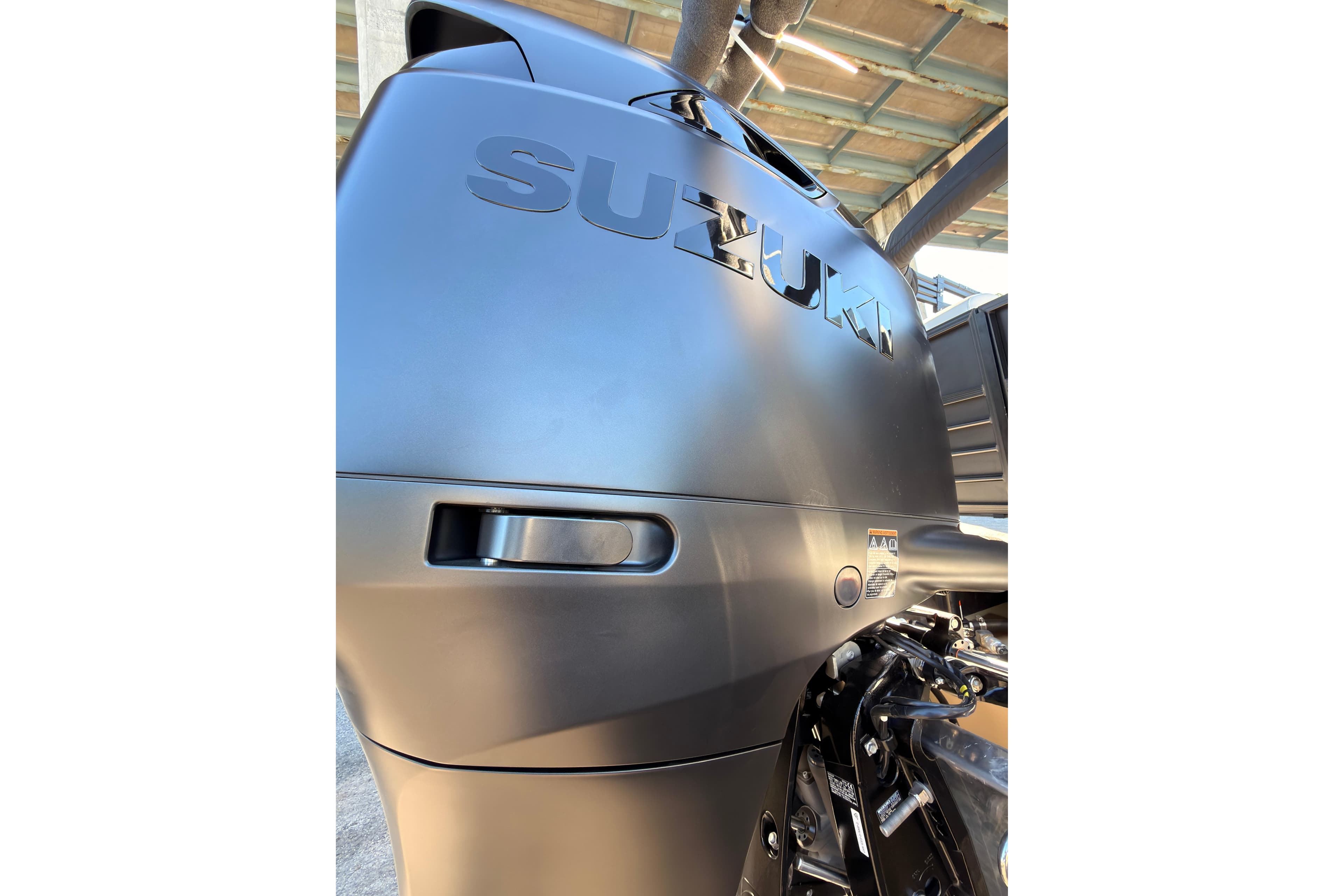 Close-up of a Suzuki outboard motor on a 2026 Coach 243 RFC boat.