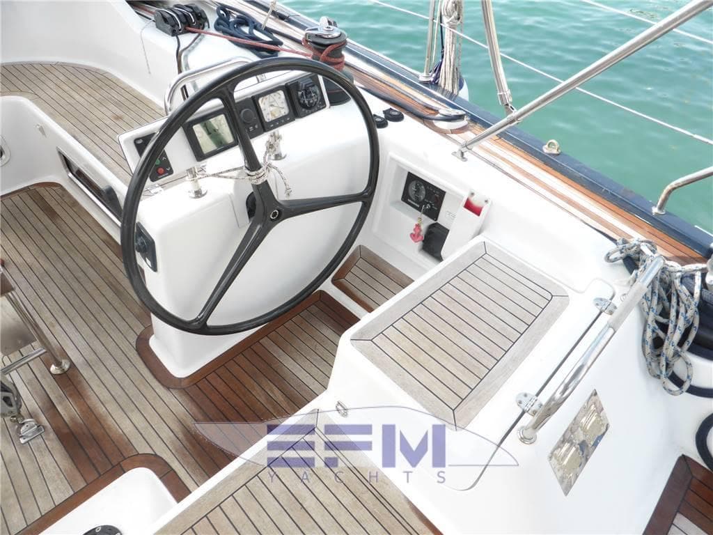 Cockpit of 2006 Hanse 531e yacht with wooden flooring and steering wheel.