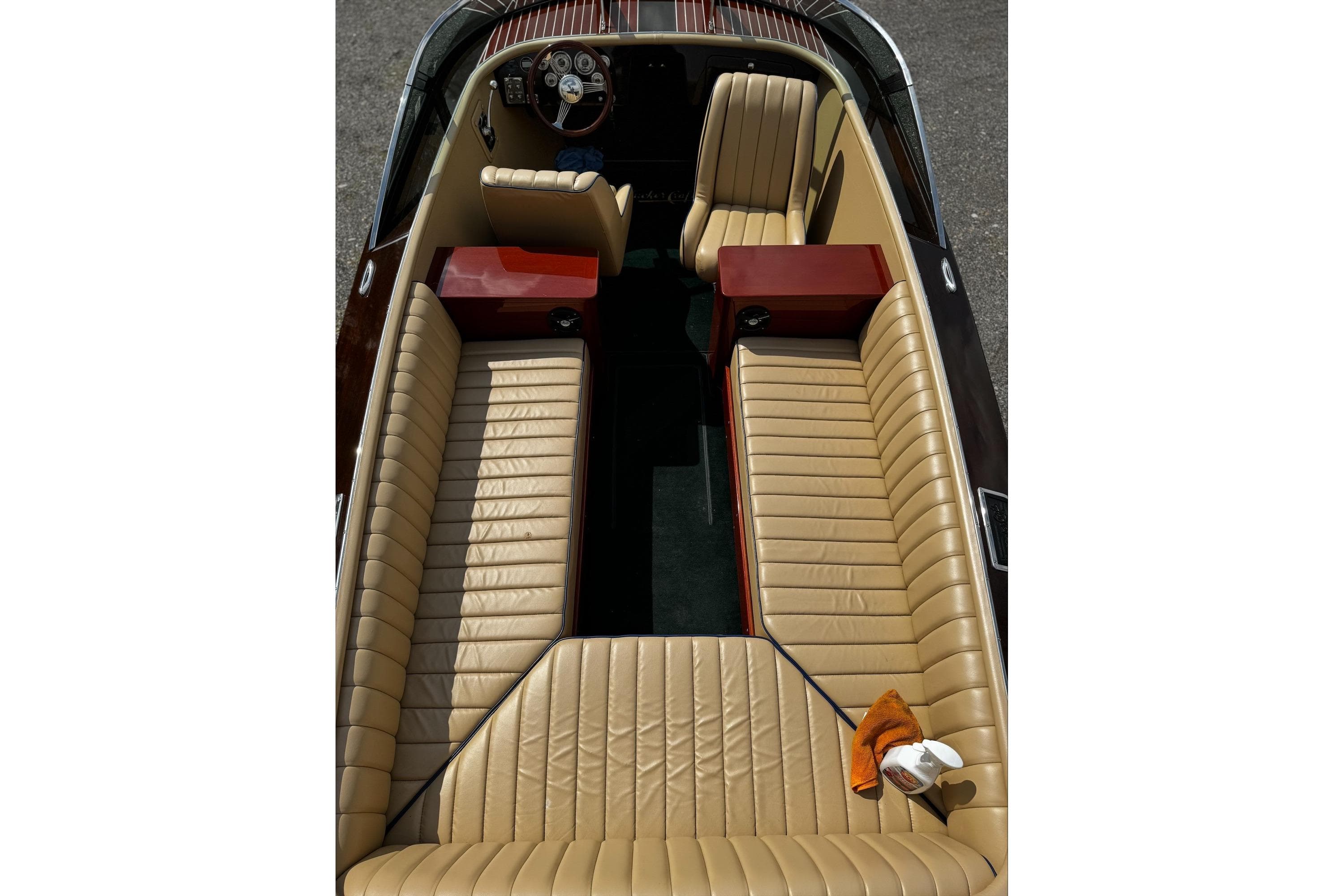 2016 Hacker-Craft 28 Sport boat interior with tan leather seating and wooden accents.