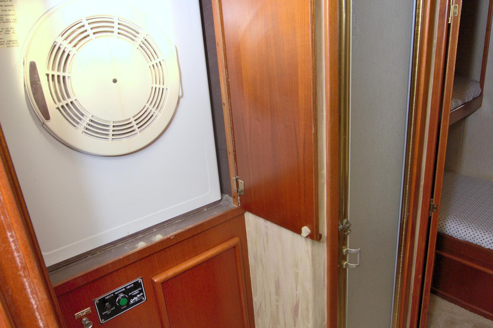 1990 Post 44 Sport Fisherman interior with dryer and wooden cabinetry.