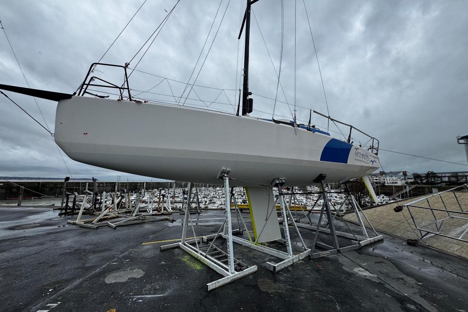 Sailboat JPK 10.30 from 2019 on dry dock under cloudy skies.