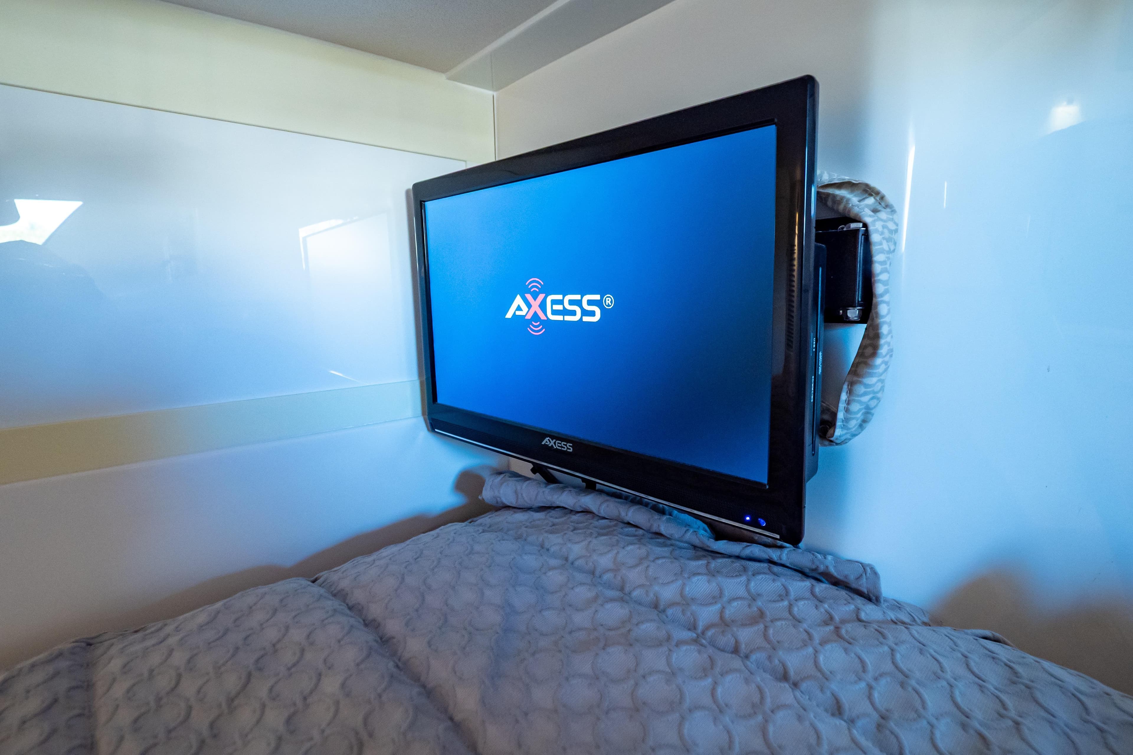 Axess TV in 2016 Intrepid 400 Cuddy cabin, mounted on wall above bed.