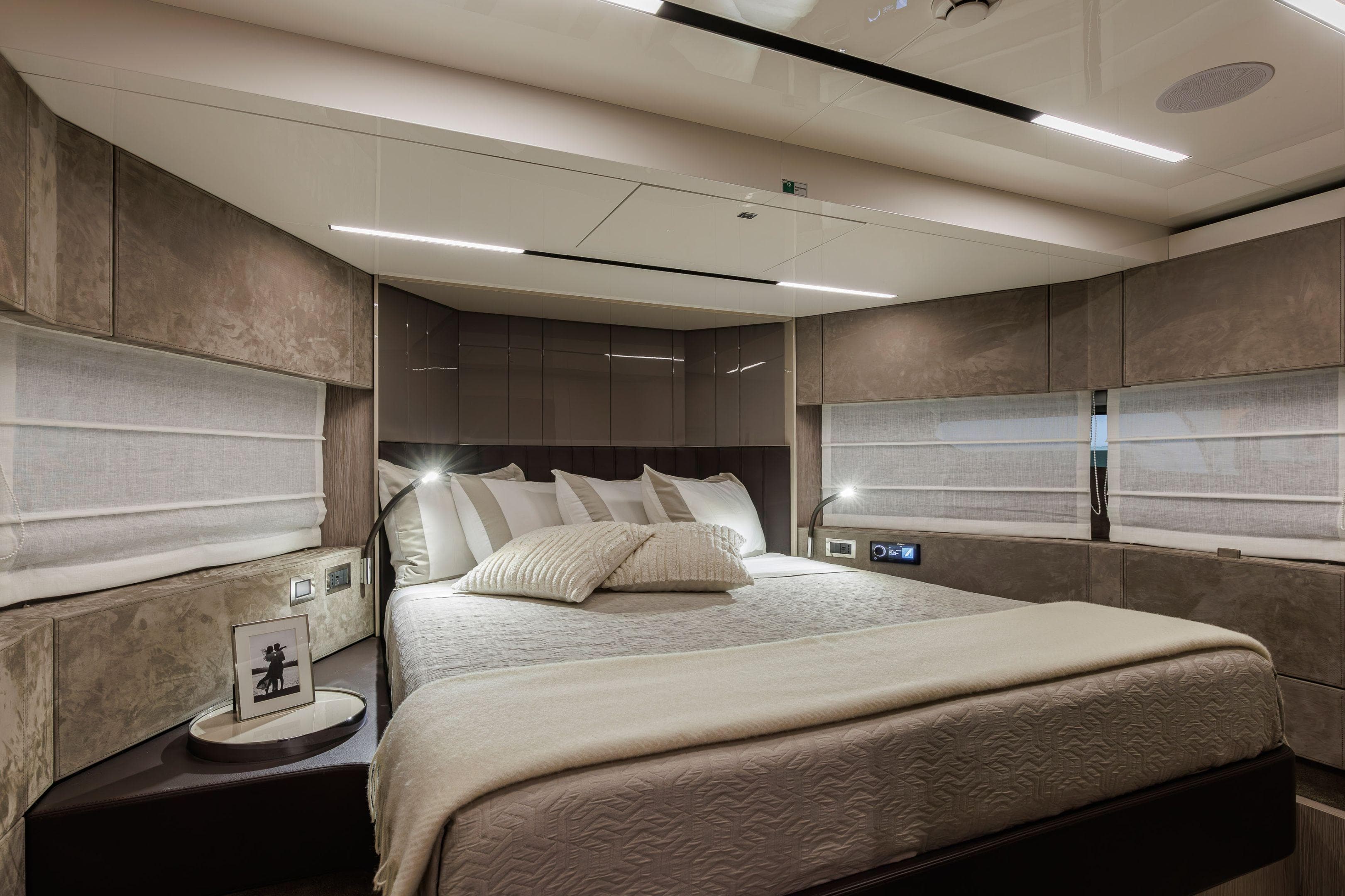 Luxurious bedroom interior of 2026 Cranchi Sessantasette 67 Corsa yacht, featuring modern design and ambient lighting.