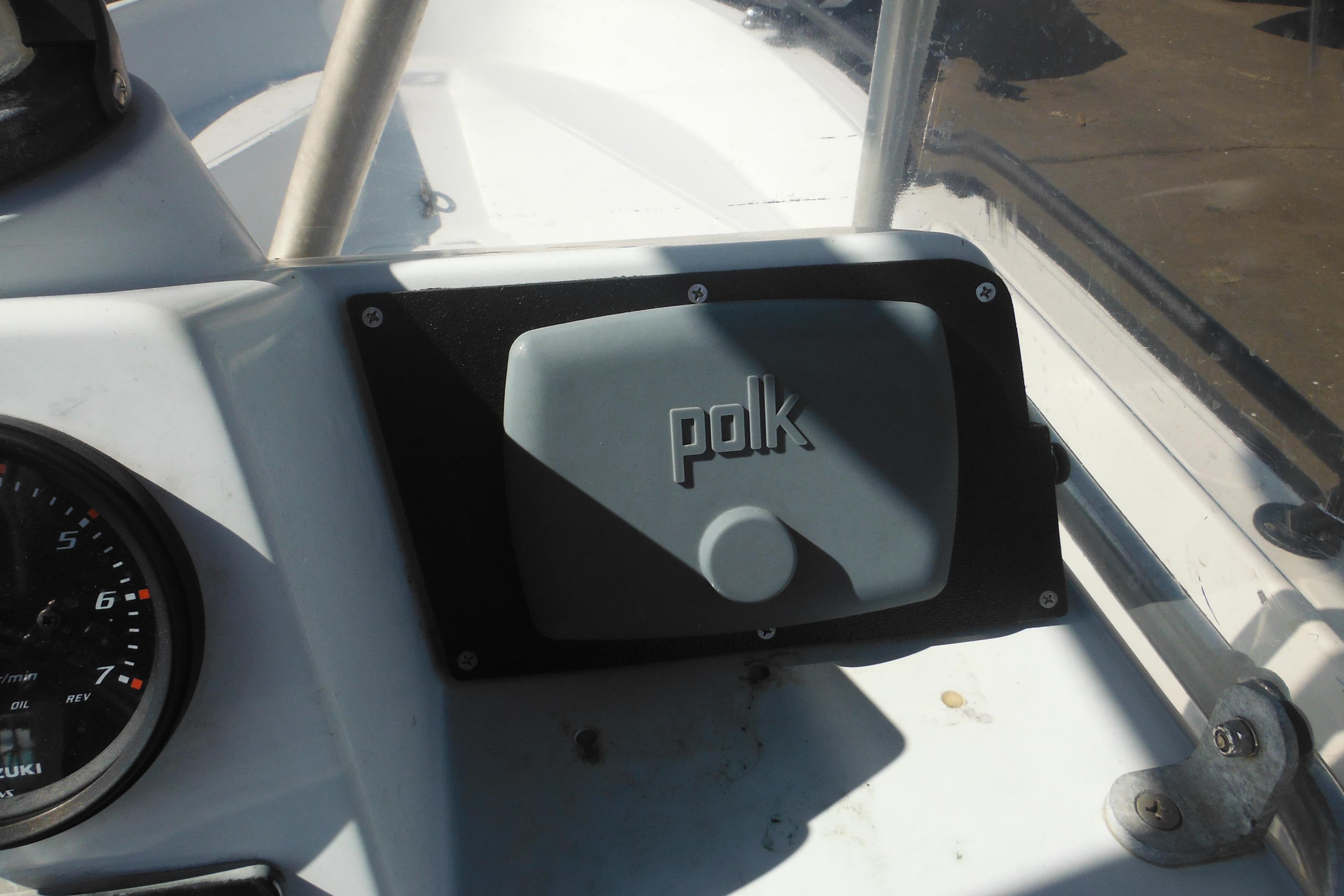 1990 Boston Whaler Guardian 22 dashboard with Polk audio cover and Suzuki gauge.
