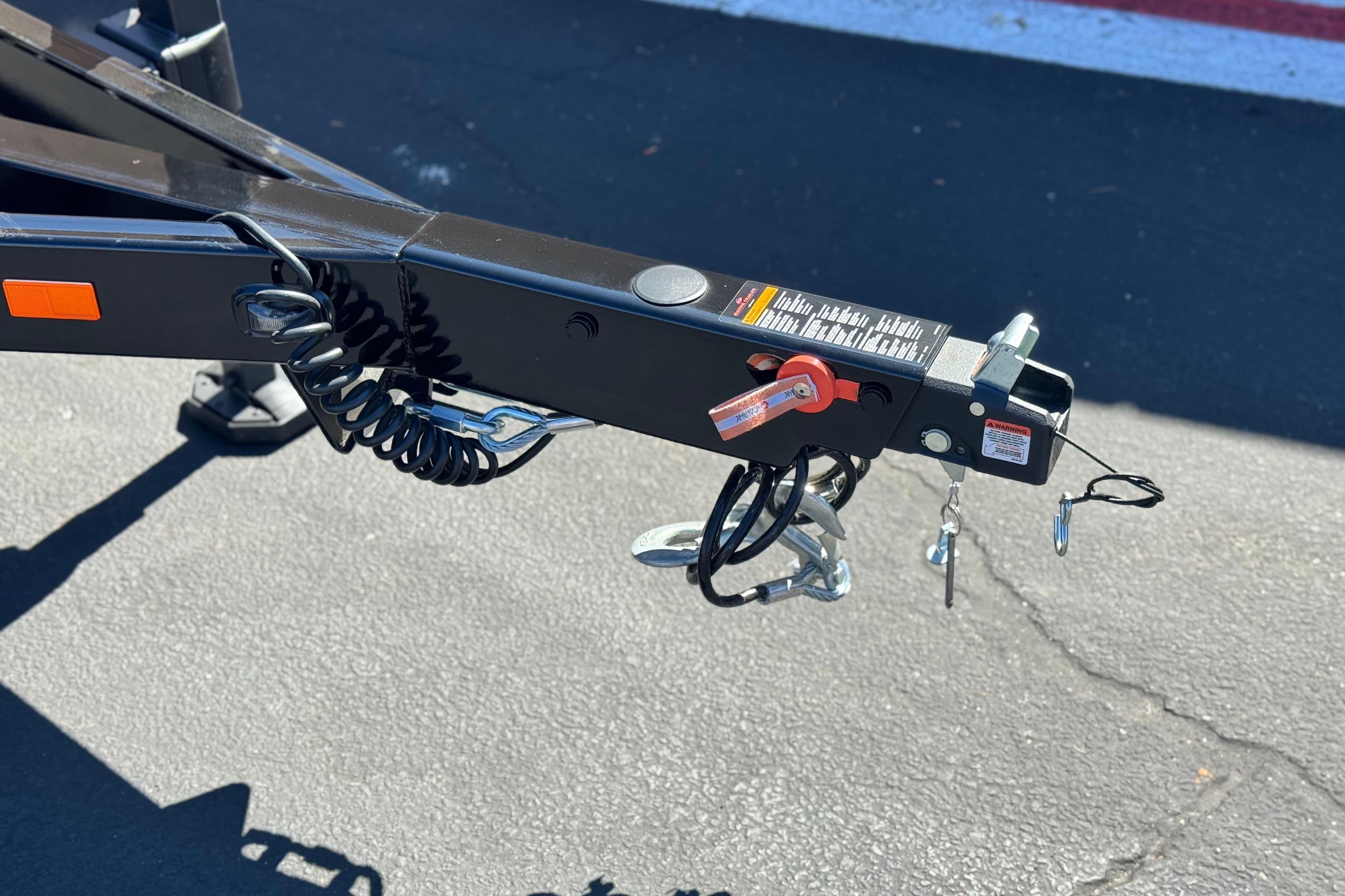 Trailer hitch of 2025 Manitou EXPLORE 24 on asphalt surface.
