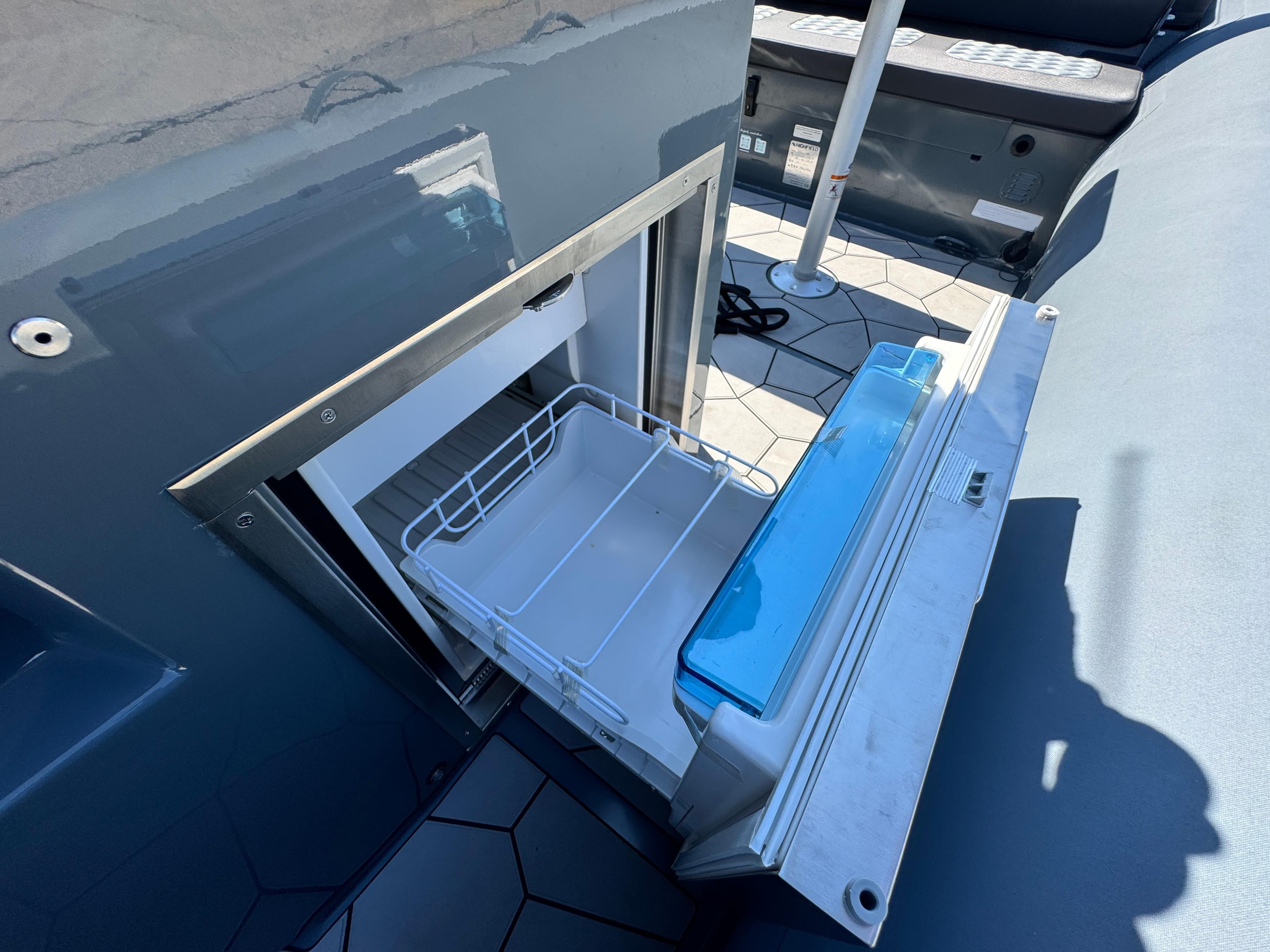 2024 Highfield Sport 900 boat with open storage compartment, showcasing interior design.