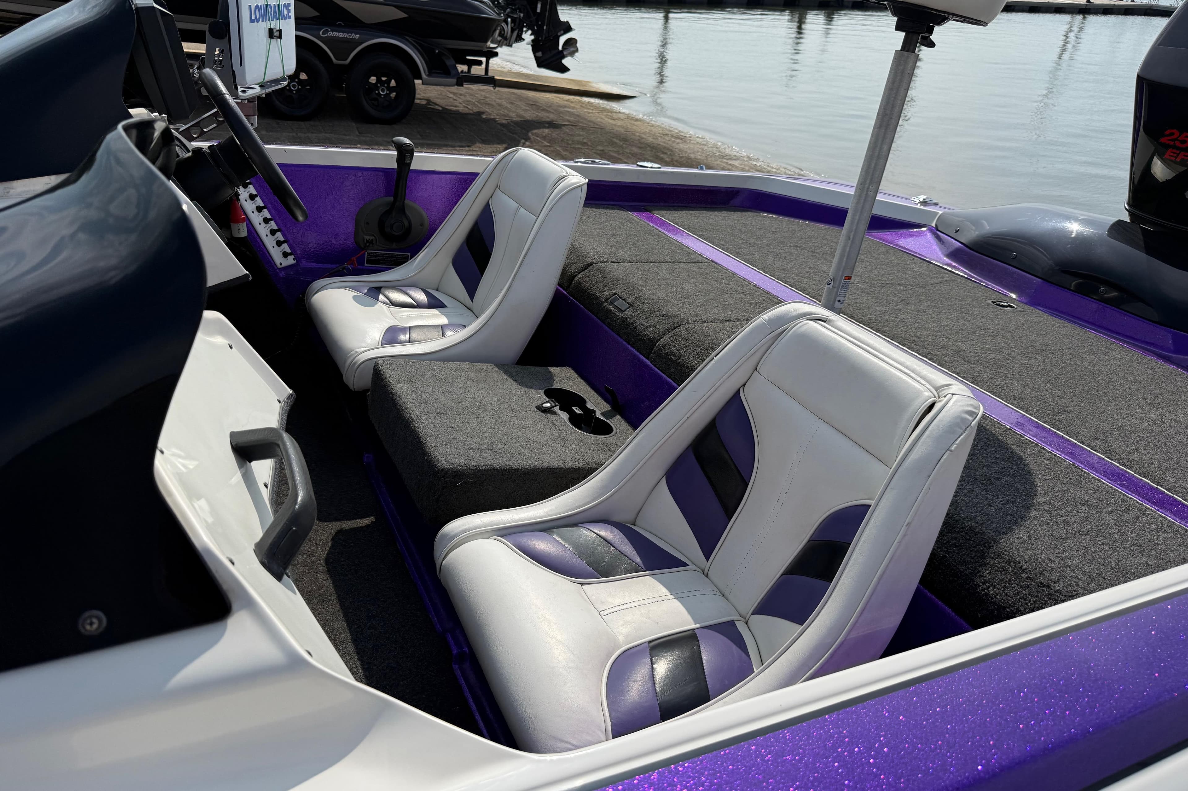 Interior of a 2002 Bullet 21XDC boat with purple and white seating.
