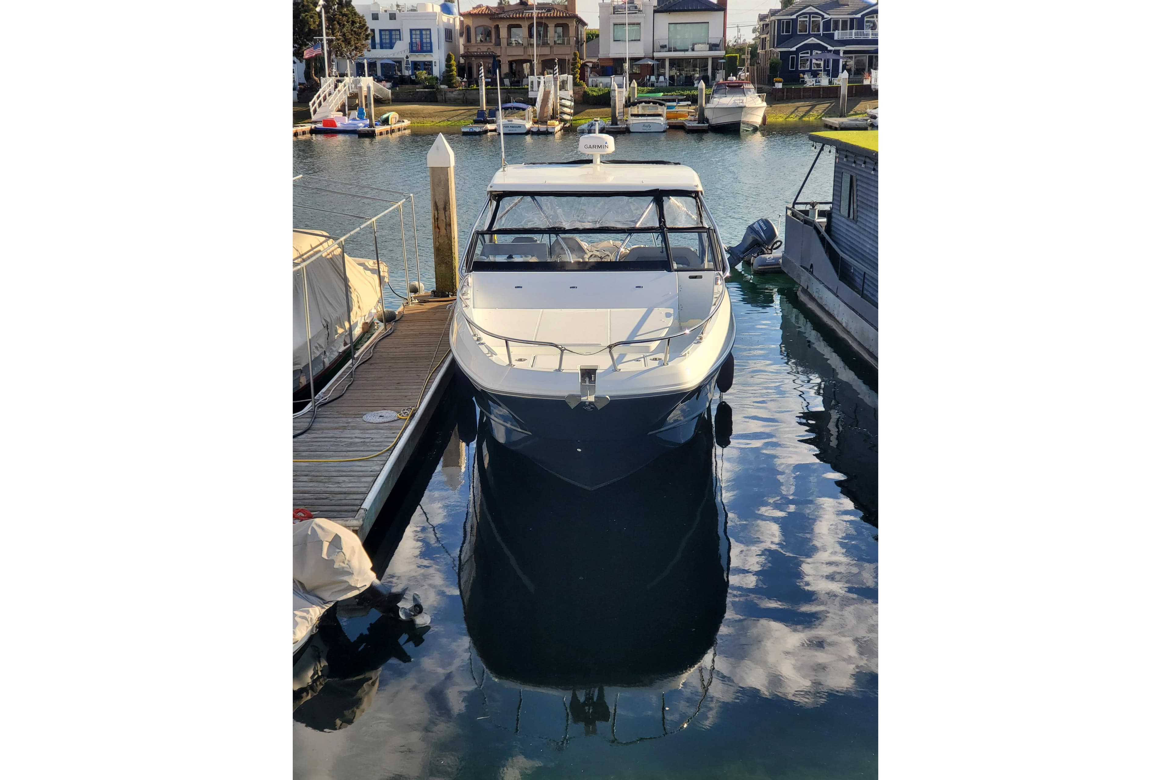 2021 Beneteau Flyer 10 docked in a marina, reflecting on calm water.