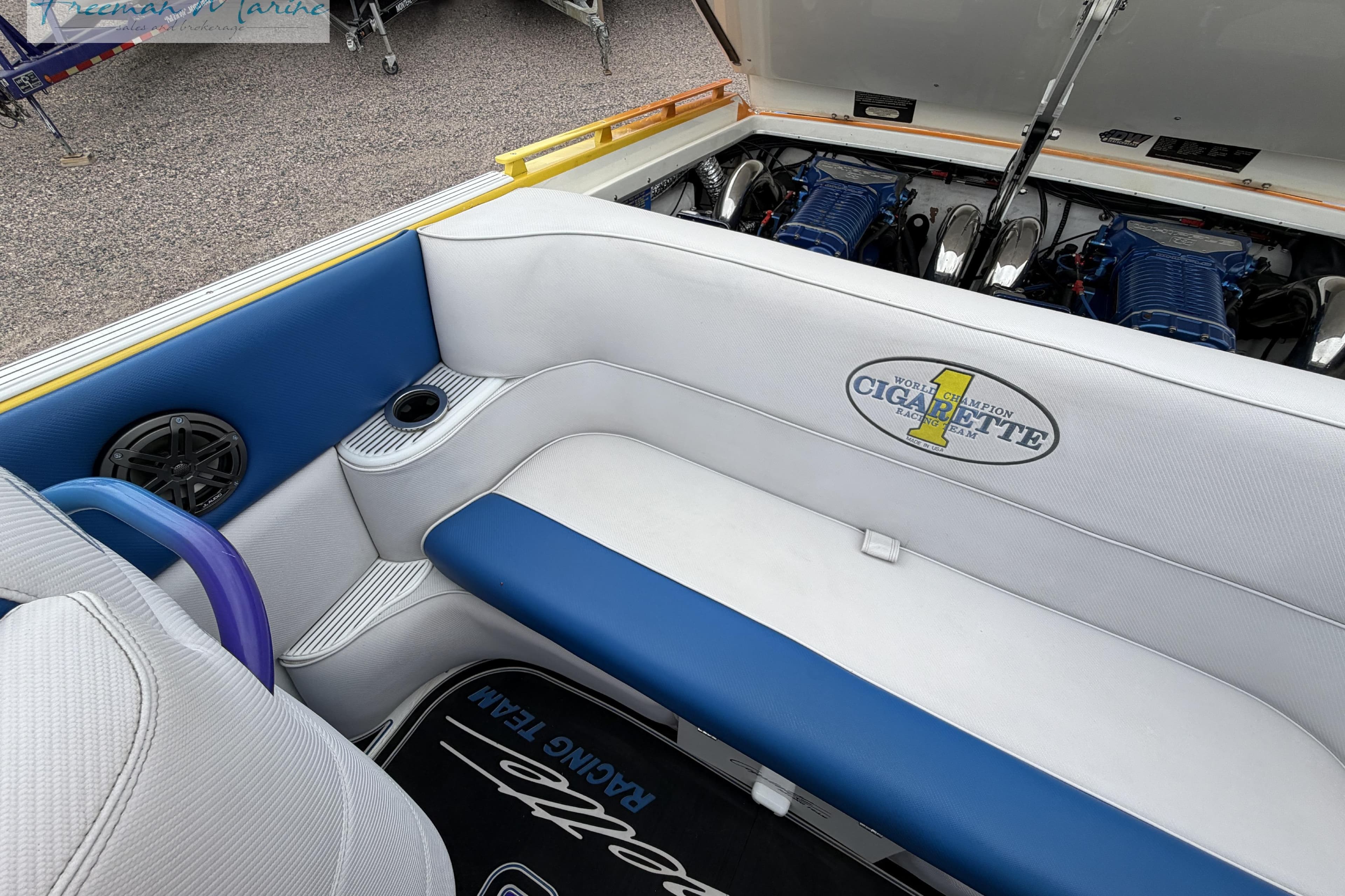 2000 Cigarette 30' Mystique boat interior with blue and white seating and visible engines.