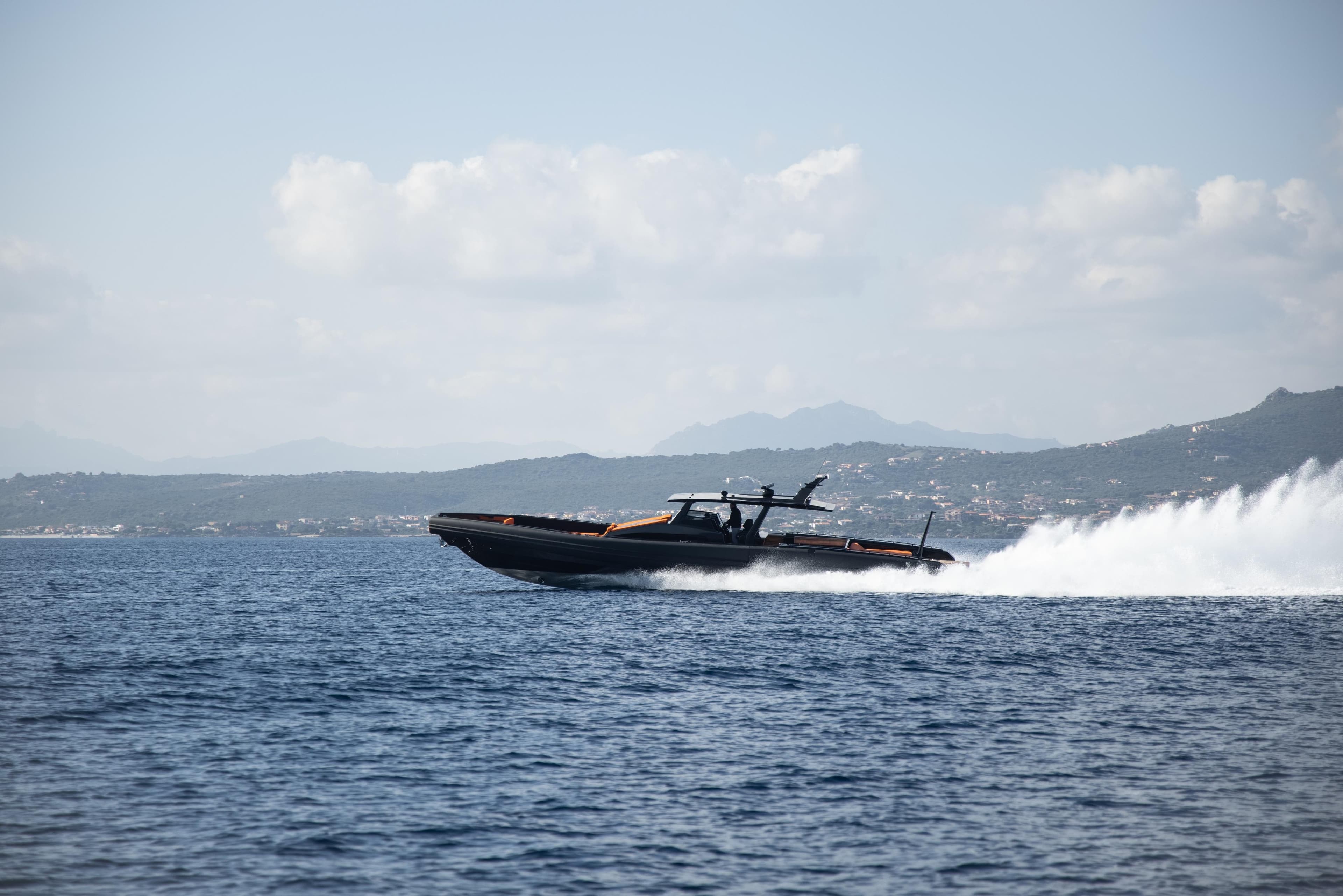 Novamarine Black Shiver 180 ASD 2022 speeding on open water with distant hills.